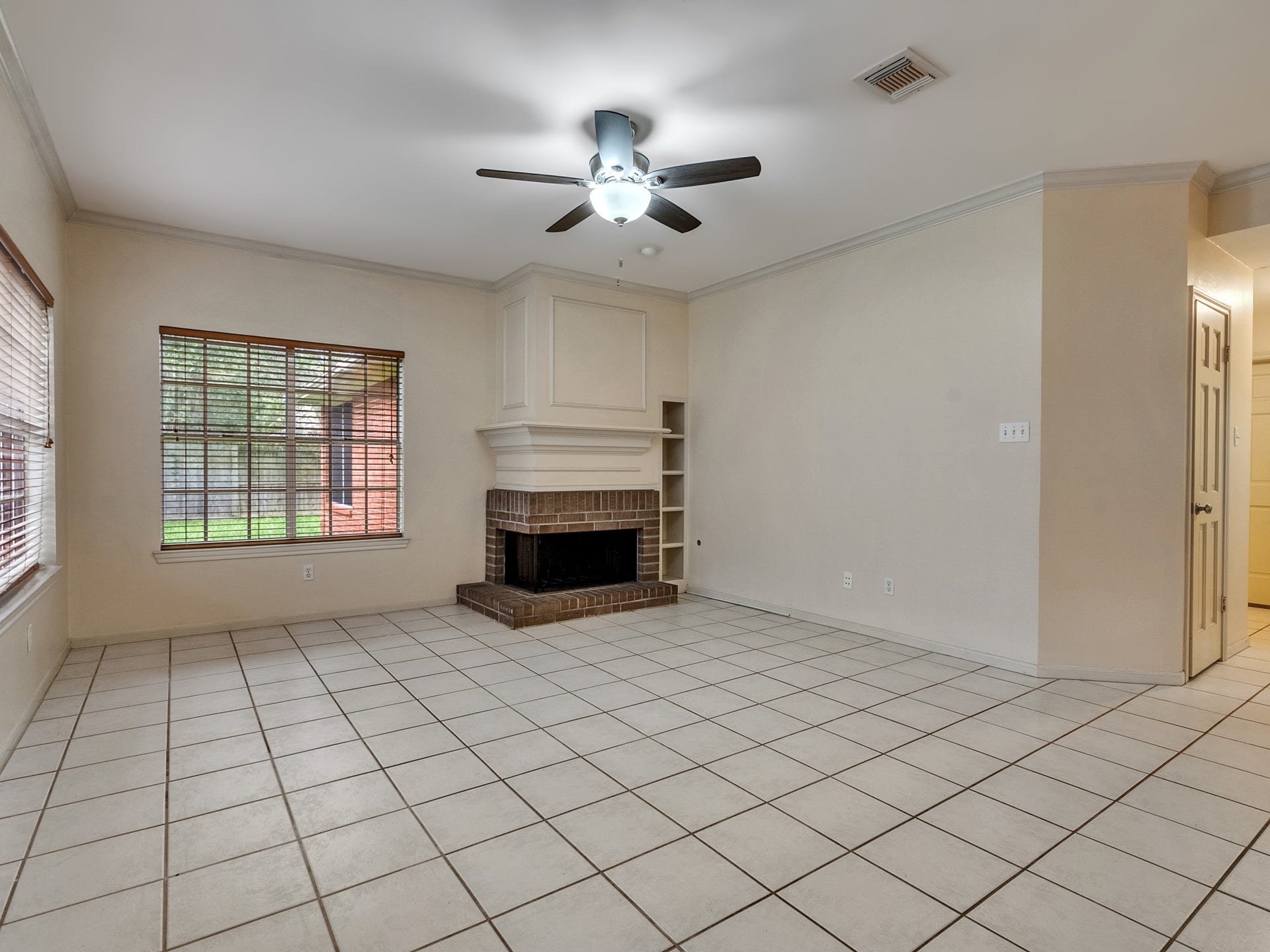 The living room comes furnished with a fireplace to stay cozy during winter nights and built-in shelving for books or photos