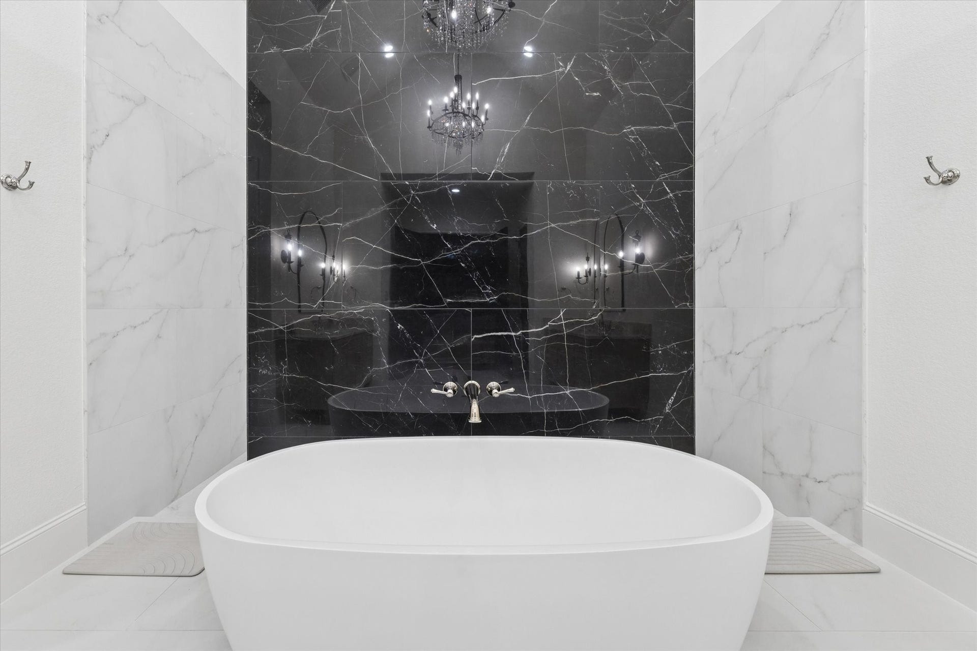 Anchored by a striking freestanding tub, this elegant retreat evokes the atmosphere of a private luxury spa. The dramatic stone feature wall creates a stunning focal point while enhancing the room's timeless sophistication.