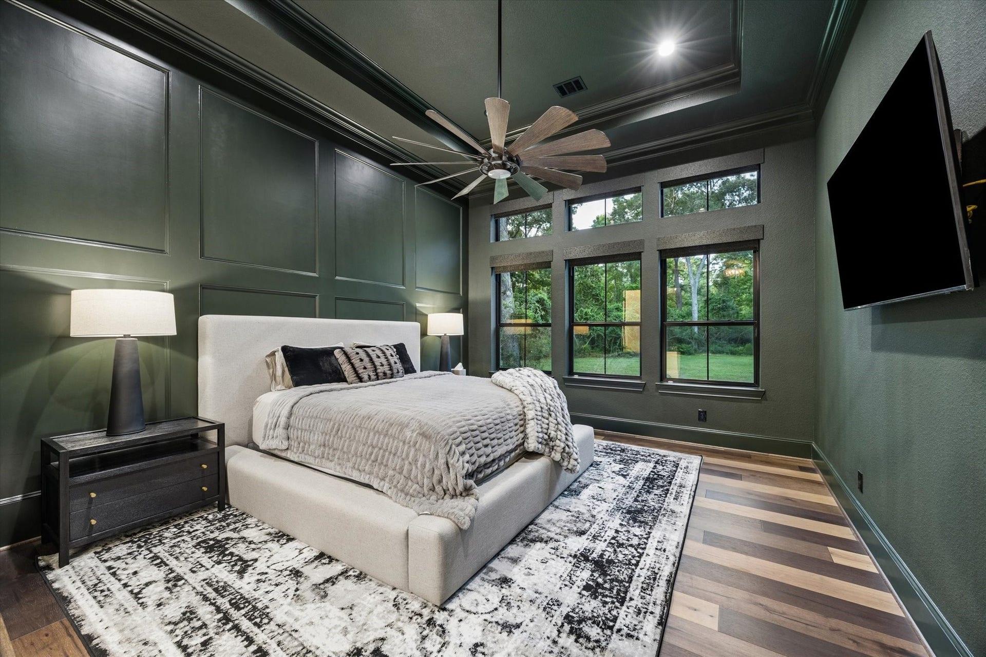 Rich designer tones and serene backyard views transform the primary suite into a sophisticated private sanctuary. Every finish has been thoughtfully curated to create an elegant balance of warmth, comfort, and contemporary luxury. Elevated ceilings, abundant natural light, and refined architectural details enhance the tranquil atmosphere, while the spacious layout provides a peaceful retreat designed for relaxation and everyday indulgence. This exceptional owner's suite offers the perfect blend.