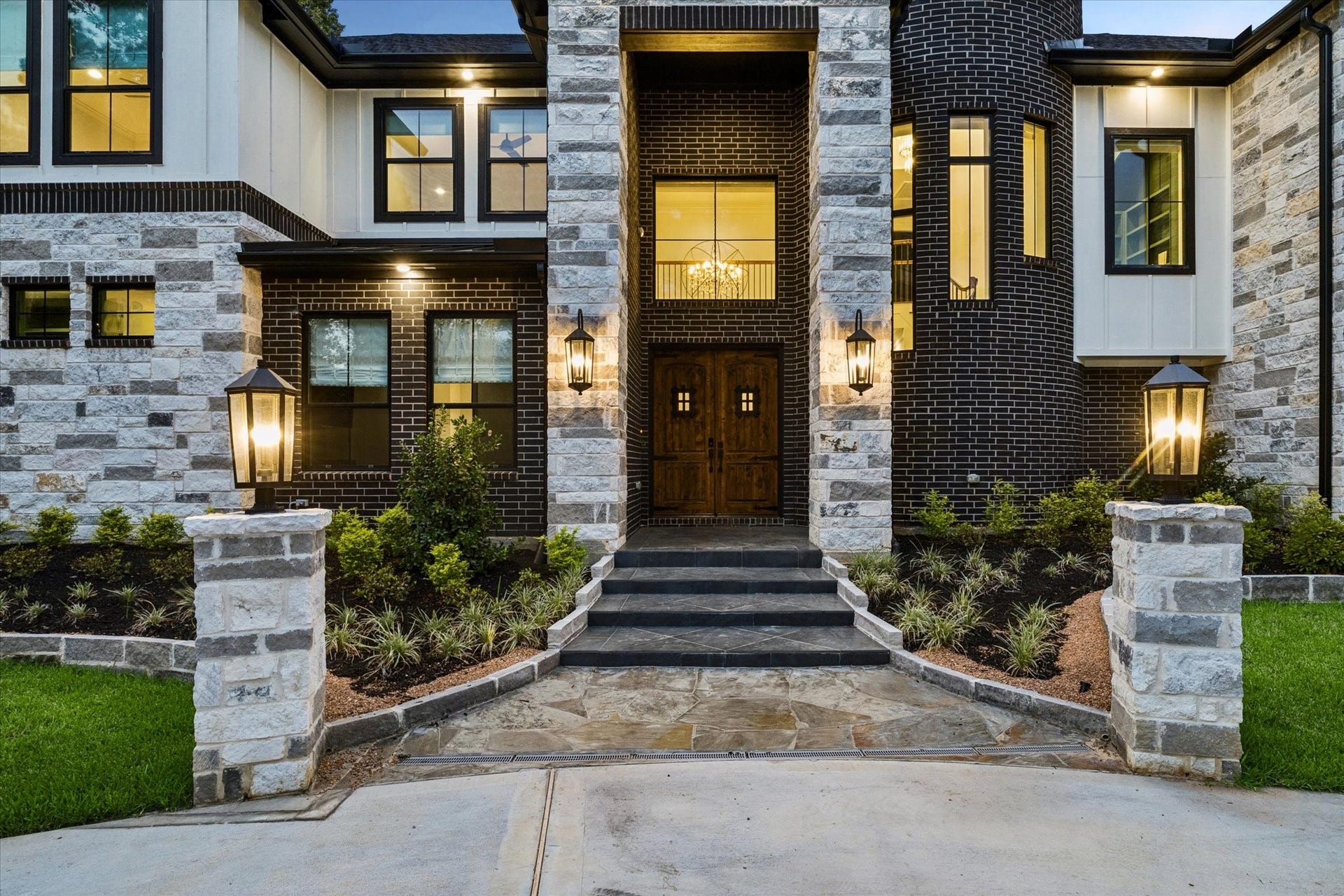 The grand front entrance sets the tone for everything that follows. Castle-inspired solid wood double doors, dramatic stonework, and soaring rotunda architecture create an unforgettable sense of arrival. As guests approach the home, they are welcomed by timeless elegance, refined craftsmanship, and beautifully landscaped surroundings. Every detail has been intentionally designed to create a warm yet impressive introduction to one of the area's most exceptional custom luxury homes.