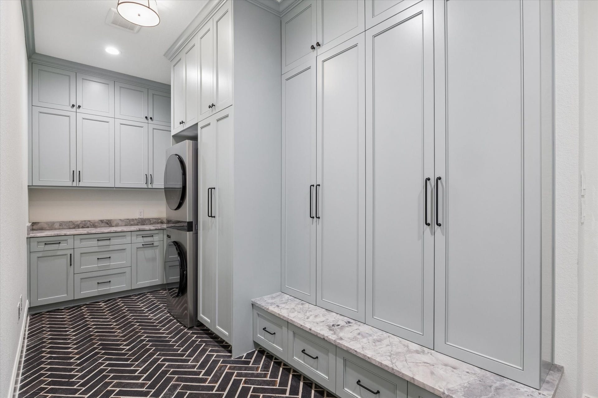 Designed by OH Design Studio, the utility room transforms everyday tasks into an elevated experience. Extensive custom cabinetry, abundant storage, and thoughtfully planned workspace blend luxury with exceptional functionality.