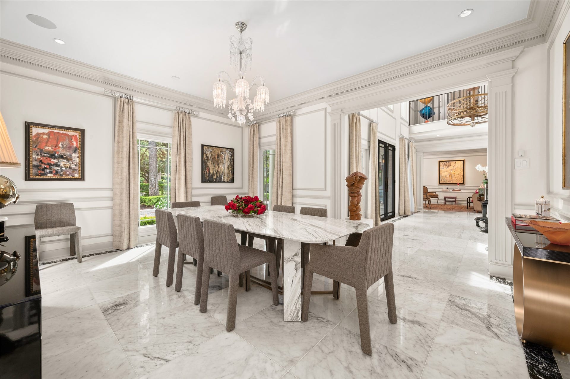 [Dining Room]
The rich marble floor extends into the dining room from the foyer. Note picture-frame molding and full-length windows .Opening at left opens into the full bar.