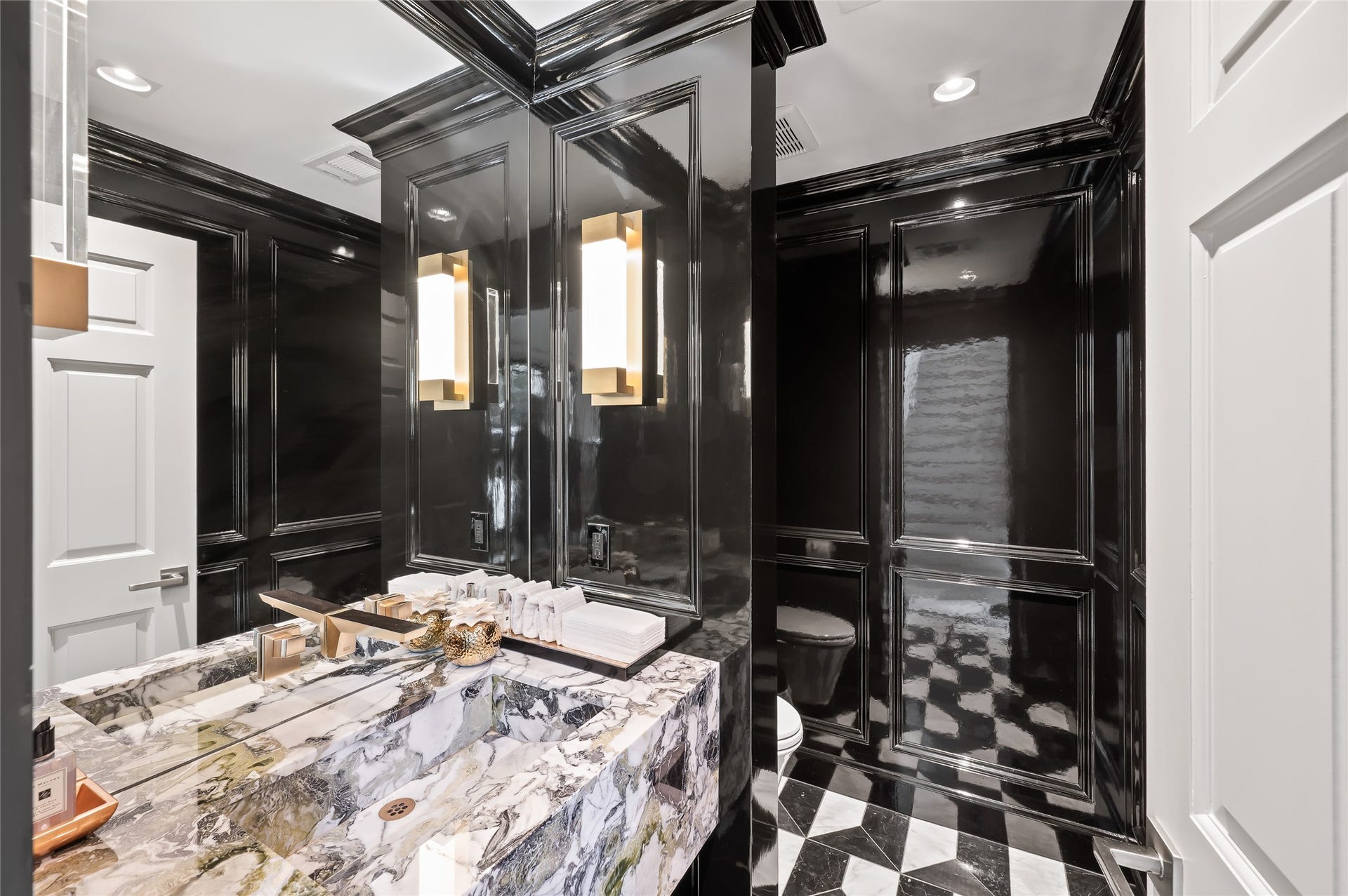 [Powder Room]
One of this home's most stunning features is this White Beauty marble, single-block, floating sink in the formal powder room. Note lacquered walls and custom marble-tile floor.