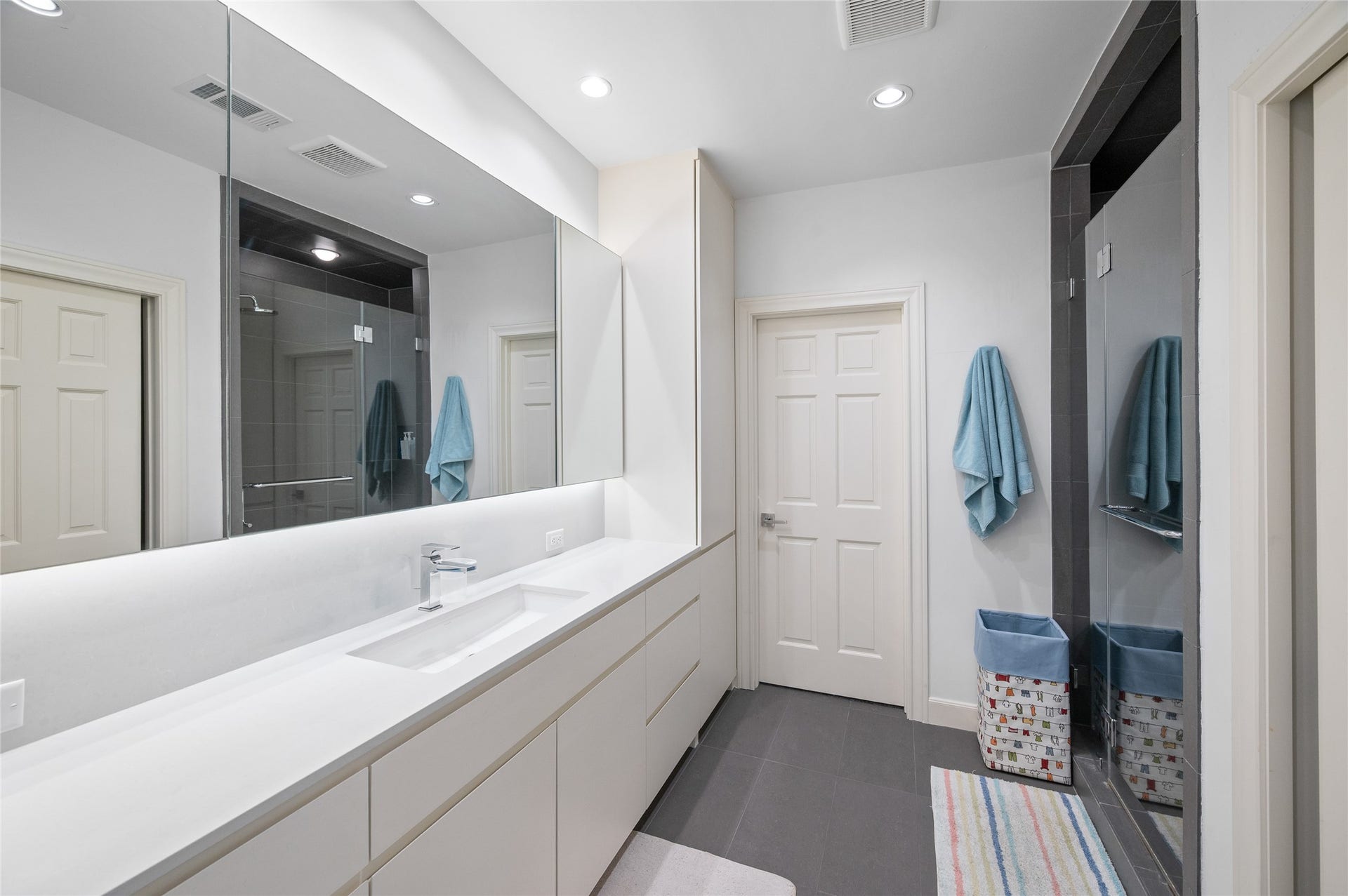 [En Suite Bath]
Note marble sink deck, glass-front shower, and porcelain tile floor.