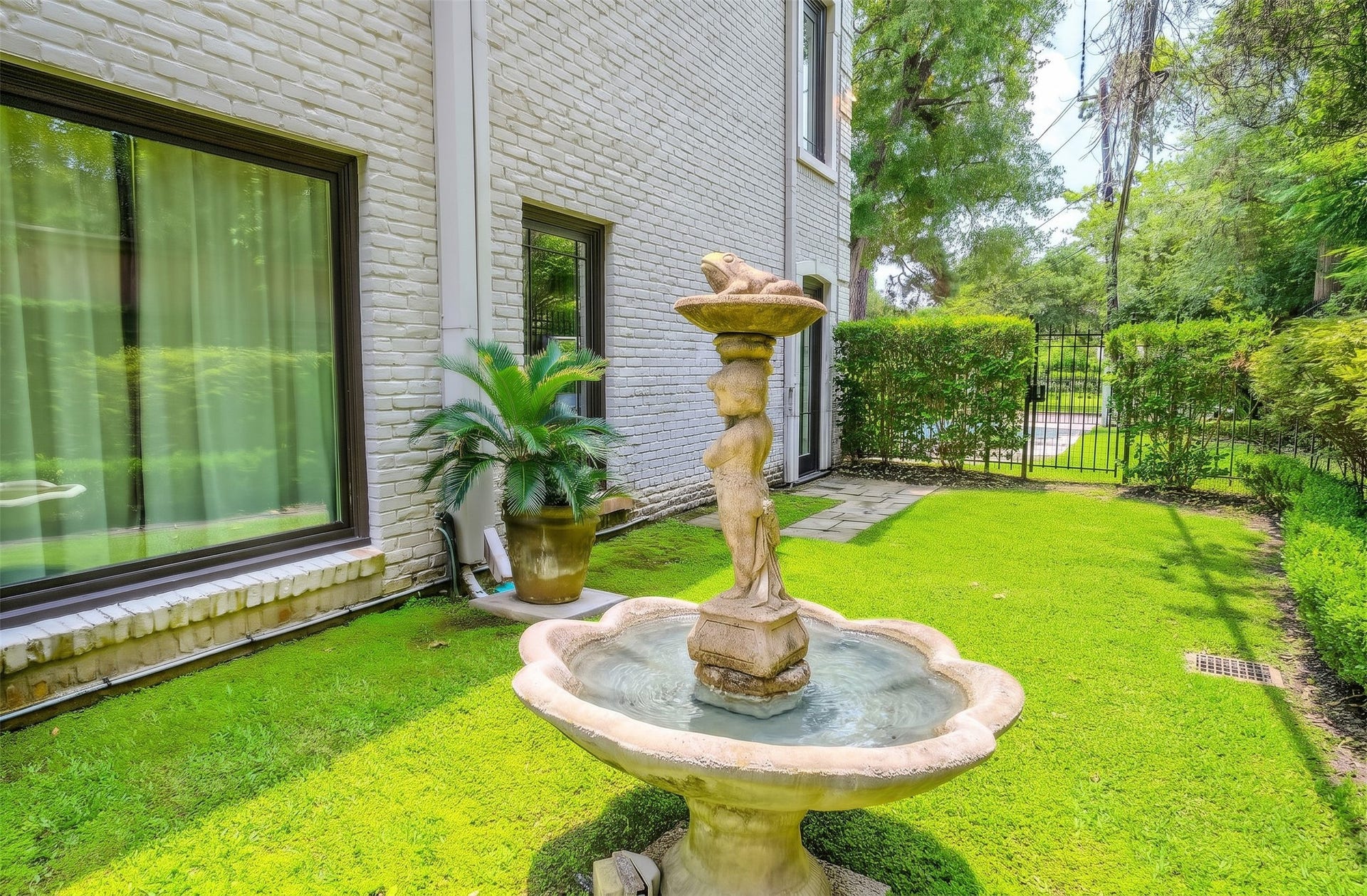 [Fountain]
Stone fountain in side yard outside of primary bedroom.