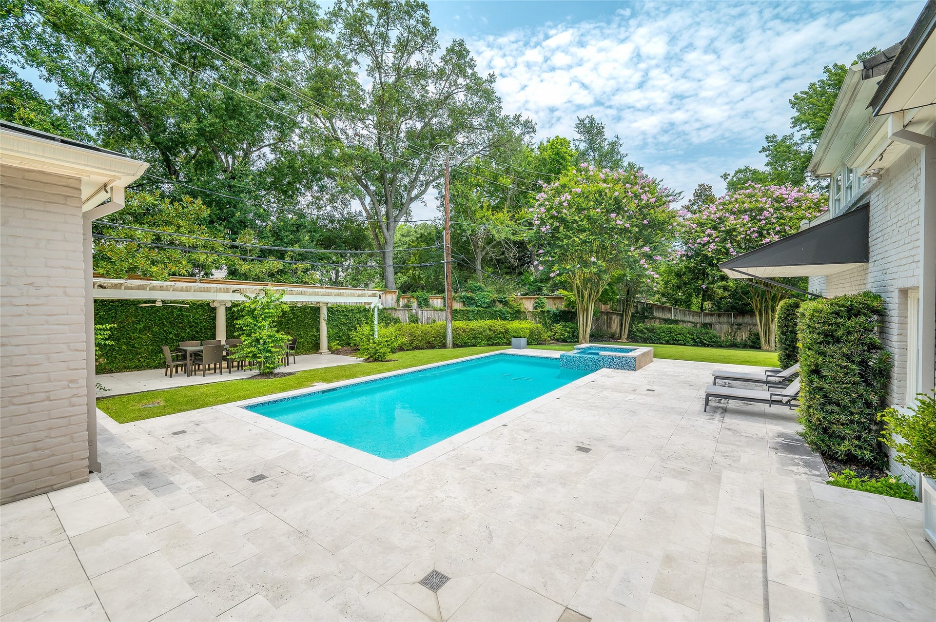 [Pool and Spa]
A wide view of the pool and spa. Cabana is at left. Note inlaid stone hardscape.