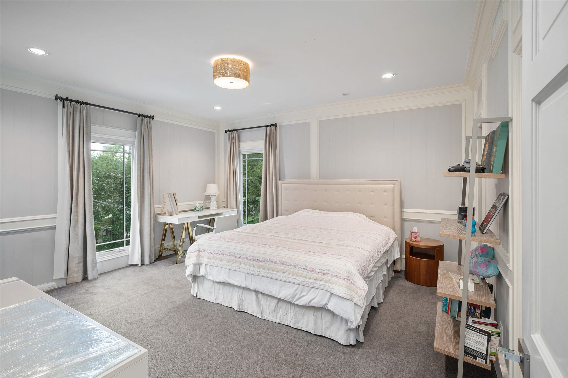 [En Suite Bedroom]
Carpeted bedrooms on the second floor are en suite and have custom-fitted closets. Note full-length windows and wall molding.
