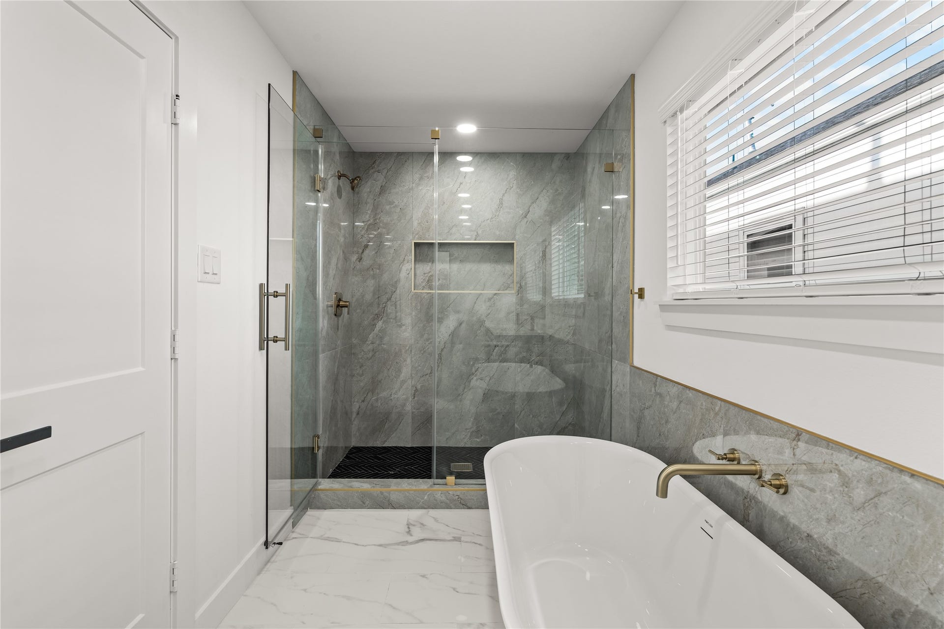 4702 & 1912 Schweikhardt Street, Houston, TX 77020 Detail-driven design. From the sleek chevron-patterned shower floor to the seamless glass enclosure, no expense was spared in crafting this sanctuary.