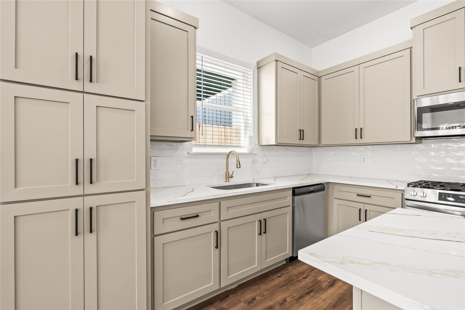 4702 & 1912 Schweikhardt Street, Houston, TX 77020 Gourmet functionality meets modern design. High-end cabinetry wraps around a gas range built for someone who loves to cook.