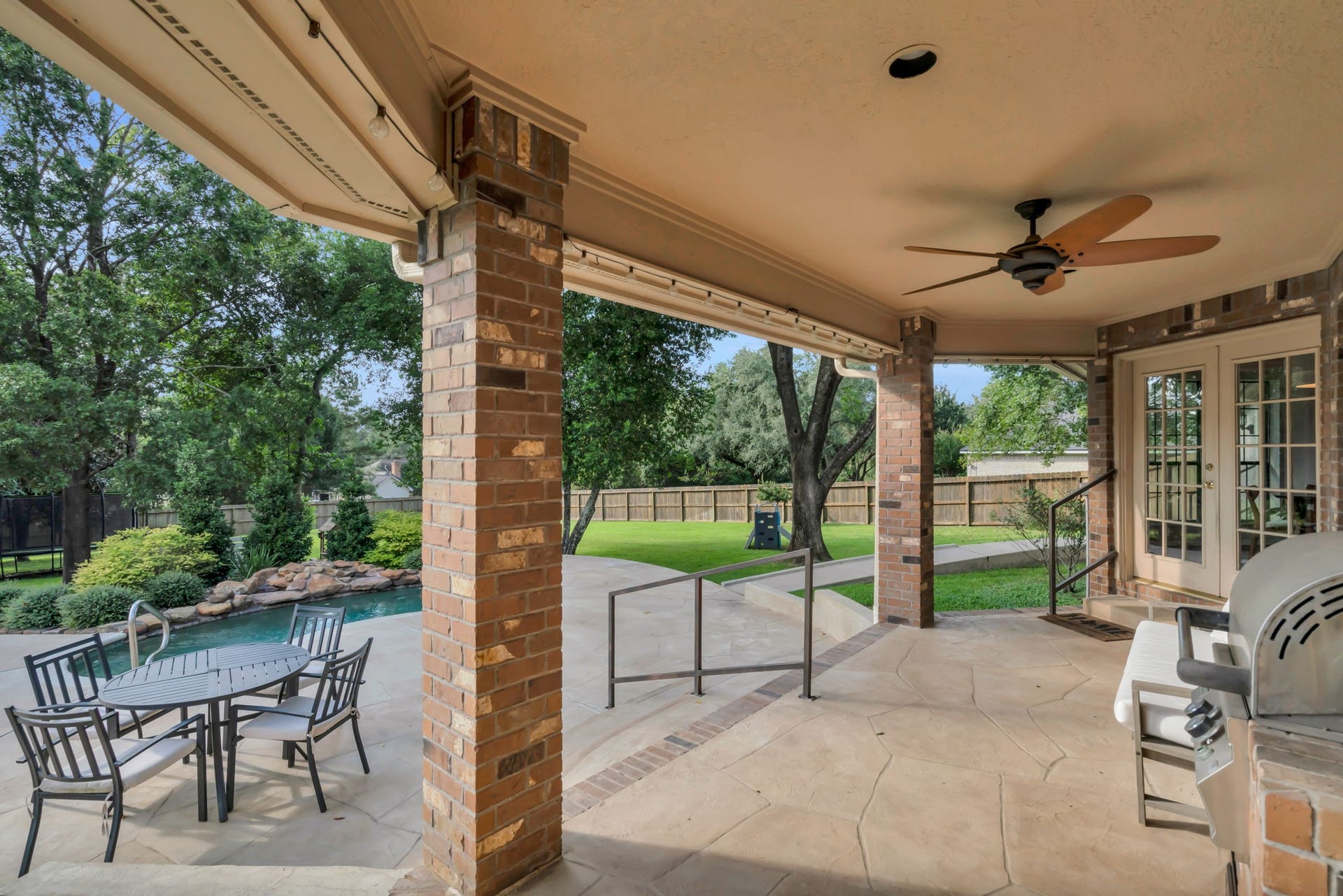 23327 Cannon Creek Trail, Tomball, TX 77377 Expansive patio overlooks the spool, backyard, and surrounding mature landscaping.