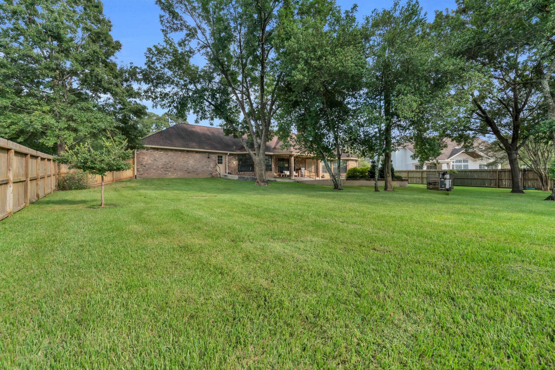 23327 Cannon Creek Trail, Tomball, TX 77377 Mature trees and a large lawn create a peaceful backyard setting.