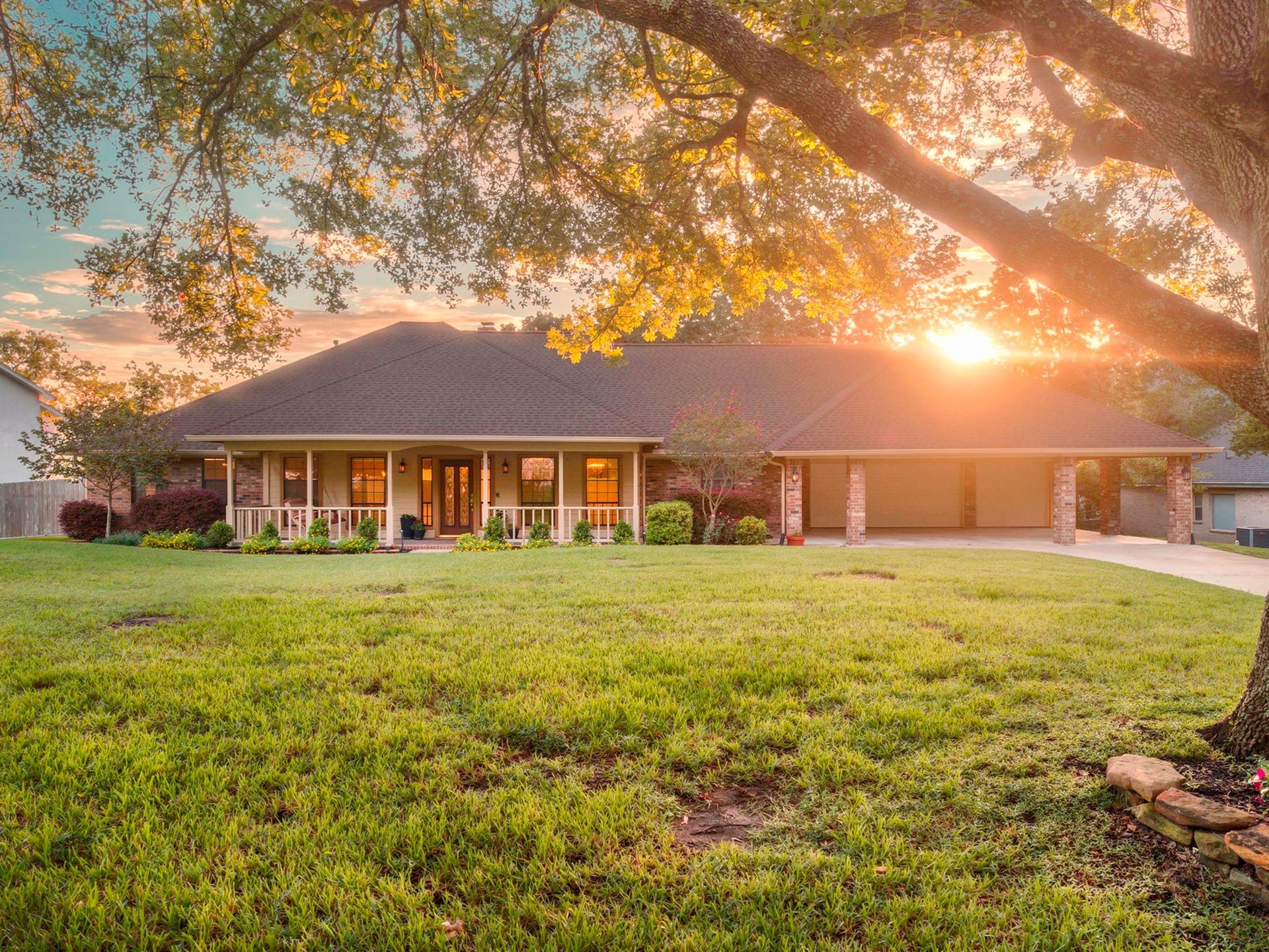 23327 Cannon Creek Trail, Tomball, TX 77377 Beautiful sunset provides the perfect backdrop for this charming one-story home and its expansive, tree-lined front yard.