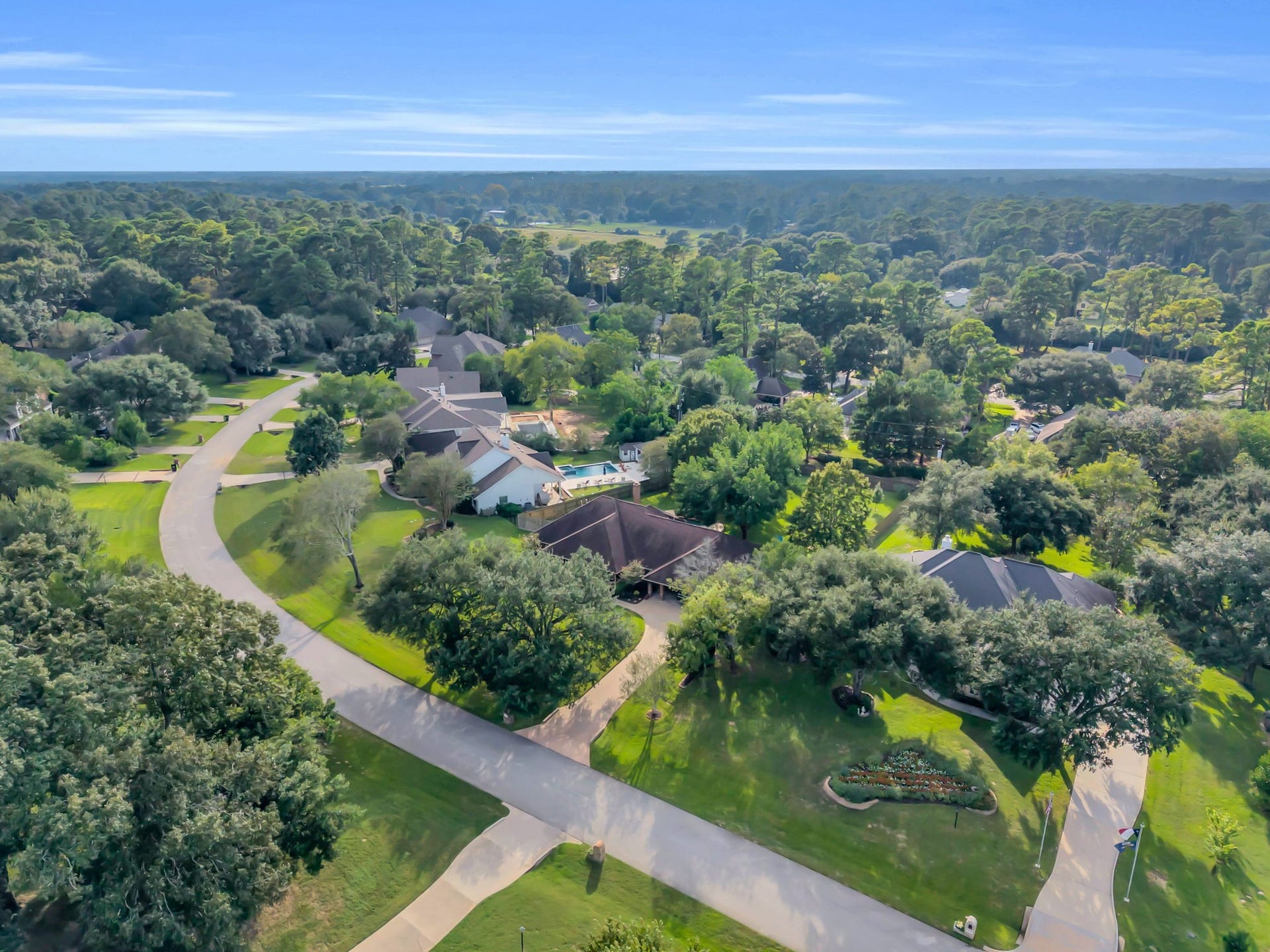 23327 Cannon Creek Trail, Tomball, TX 77377 Aerial view showcases the homes spacious setting in established Powder Mill Estates, surrounded by beautiful mature trees.