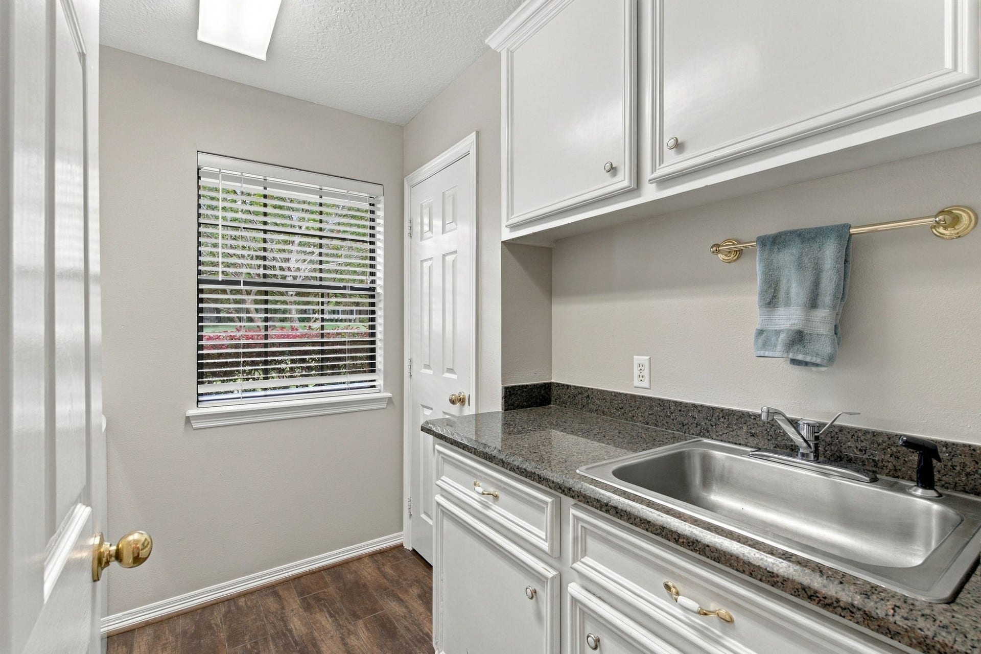 23327 Cannon Creek Trail, Tomball, TX 77377 Laundry room features cabinetry, counter space, and a convenient utility sink.