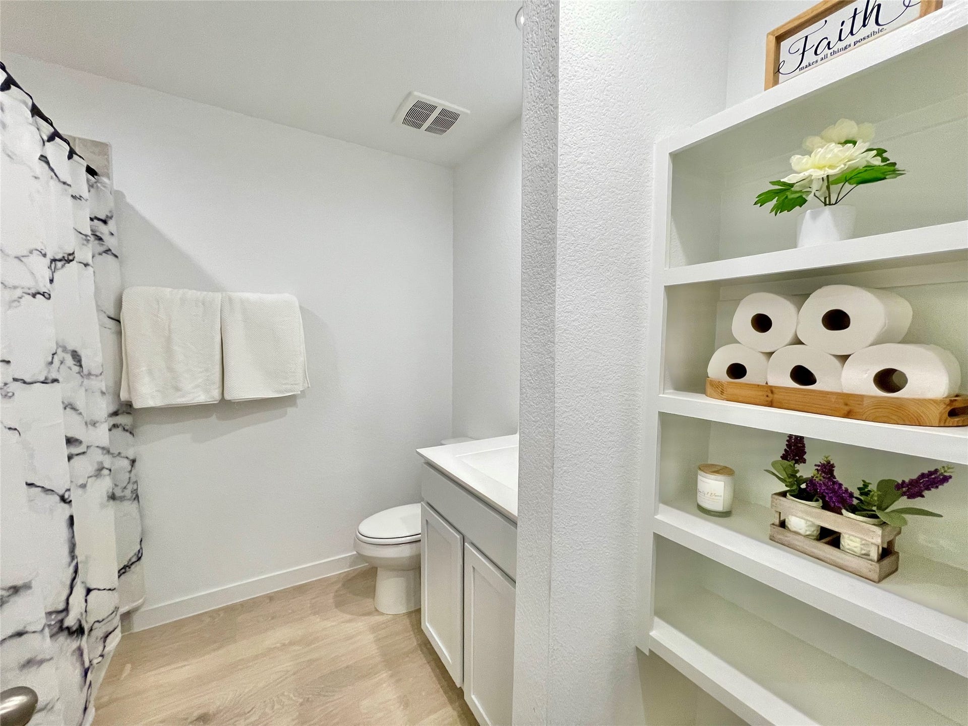 31722 Farlam Farms Trail, Fulshear, TX 77441 Immaculate guest bathroom featuring smart, custom built-in shelving for flawless linen storage and easy organization.
