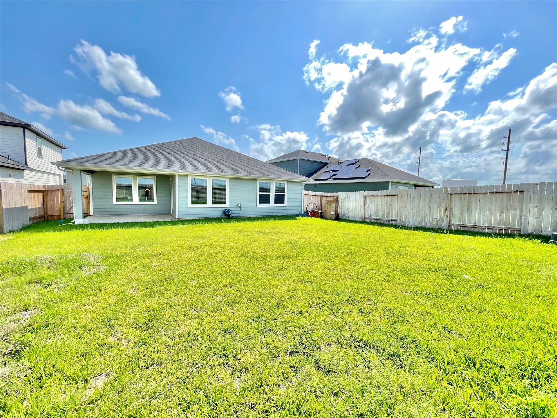 31722 Farlam Farms Trail, Fulshear, TX 77441 Rear elevation view highlighting the pristine condition of the home and the incredible scale of the lawn.