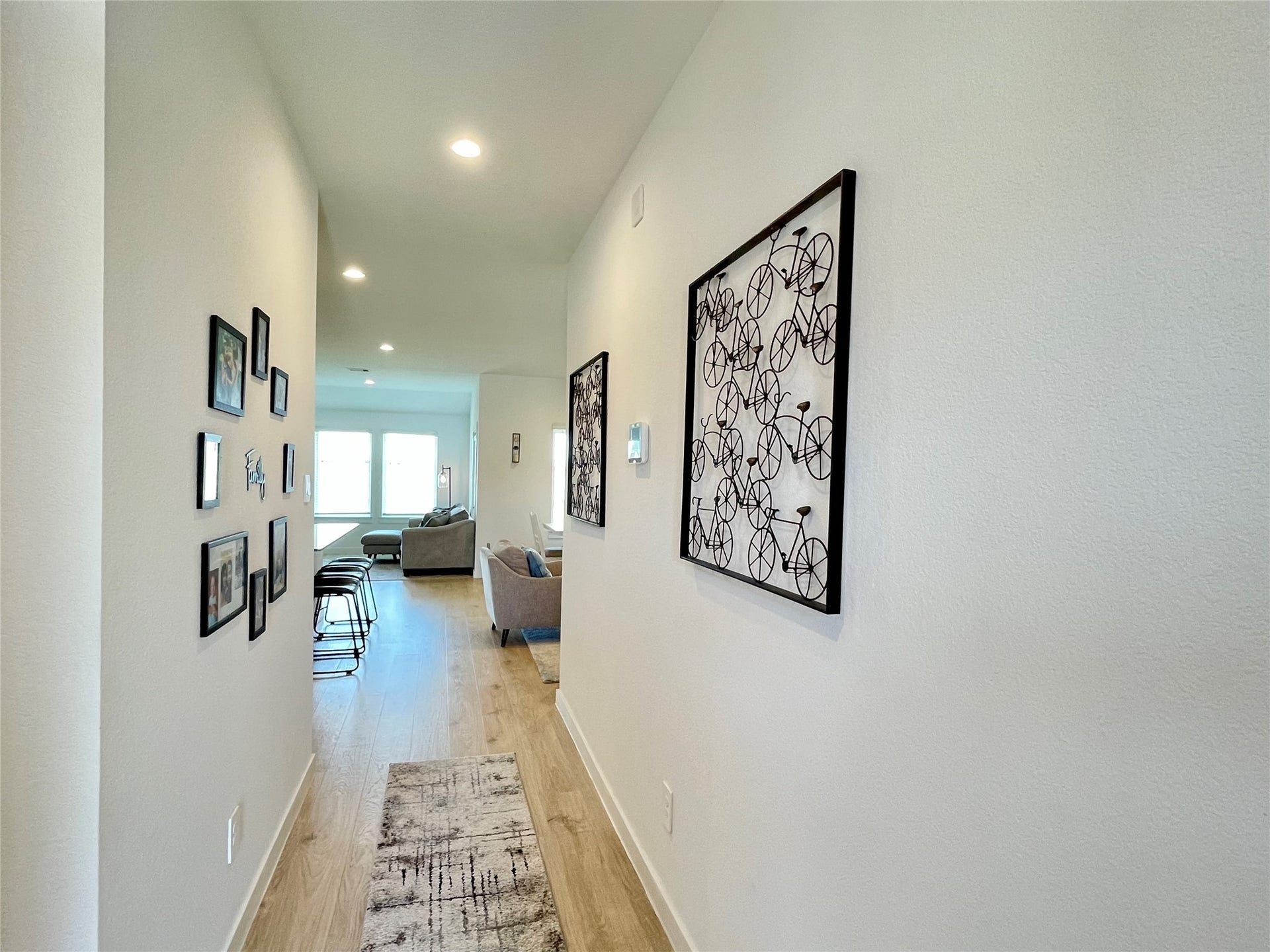 31722 Farlam Farms Trail, Fulshear, TX 77441 This beautifully lit corridor offers the perfect gallery wall potential, connecting the private quarters with sophisticated easeaccent furniture placement and a seamless transition into the heart of the home.