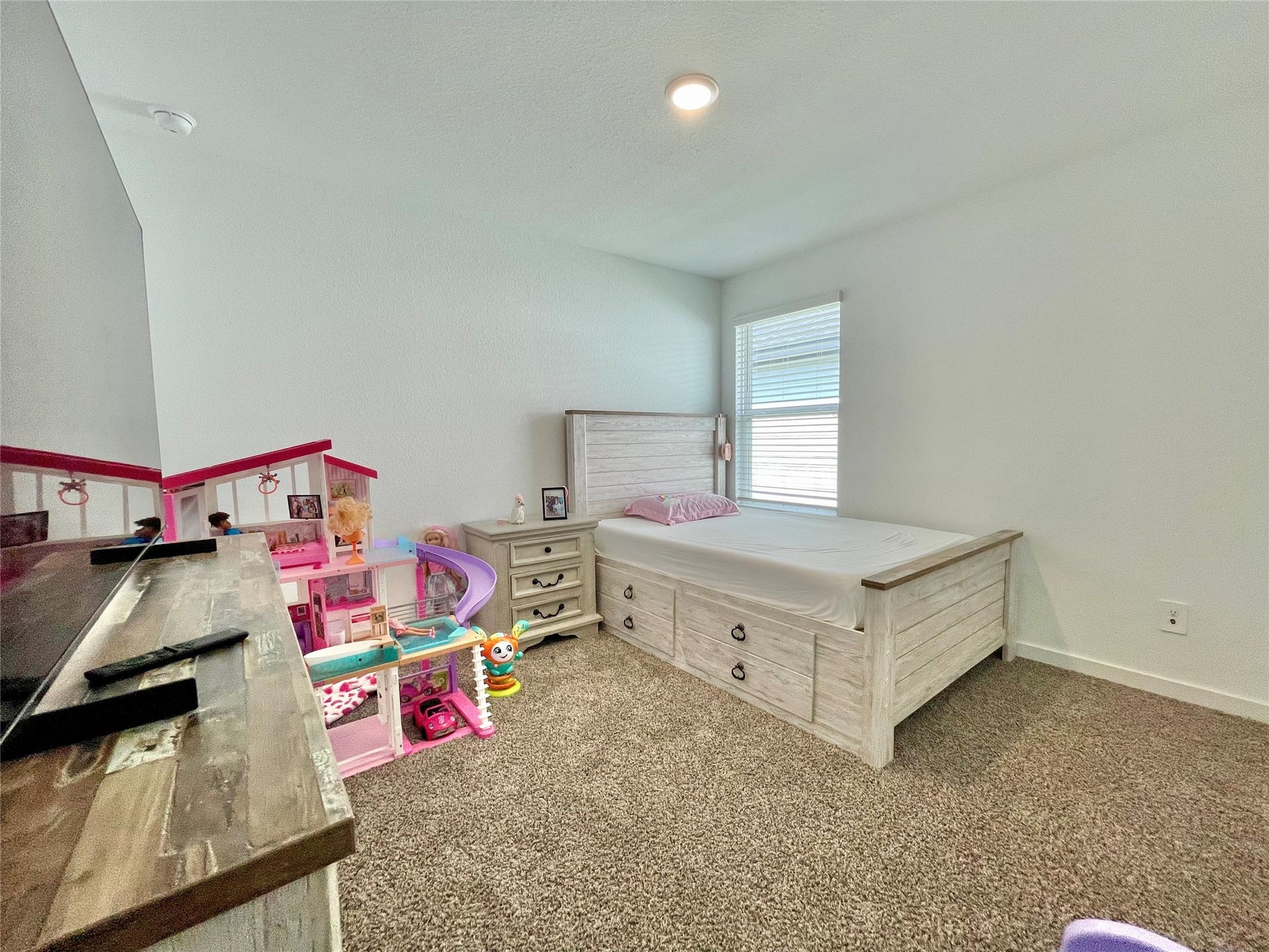 31722 Farlam Farms Trail, Fulshear, TX 77441 Another perspective of this cheerful bedroom showcases the generous floor plan, leaving plenty of room for play areas and toy storage.