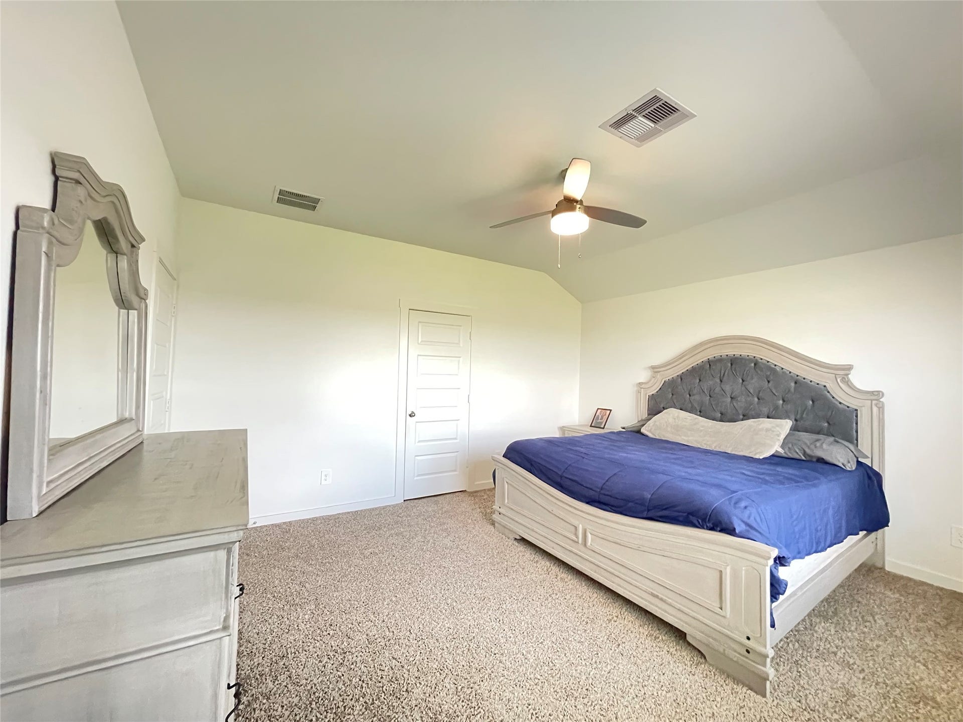31722 Farlam Farms Trail, Fulshear, TX 77441 Retreat to the grand primary suitea serene oasis designed for absolute rest, featuring plush carpeting and a cooling ceiling fan