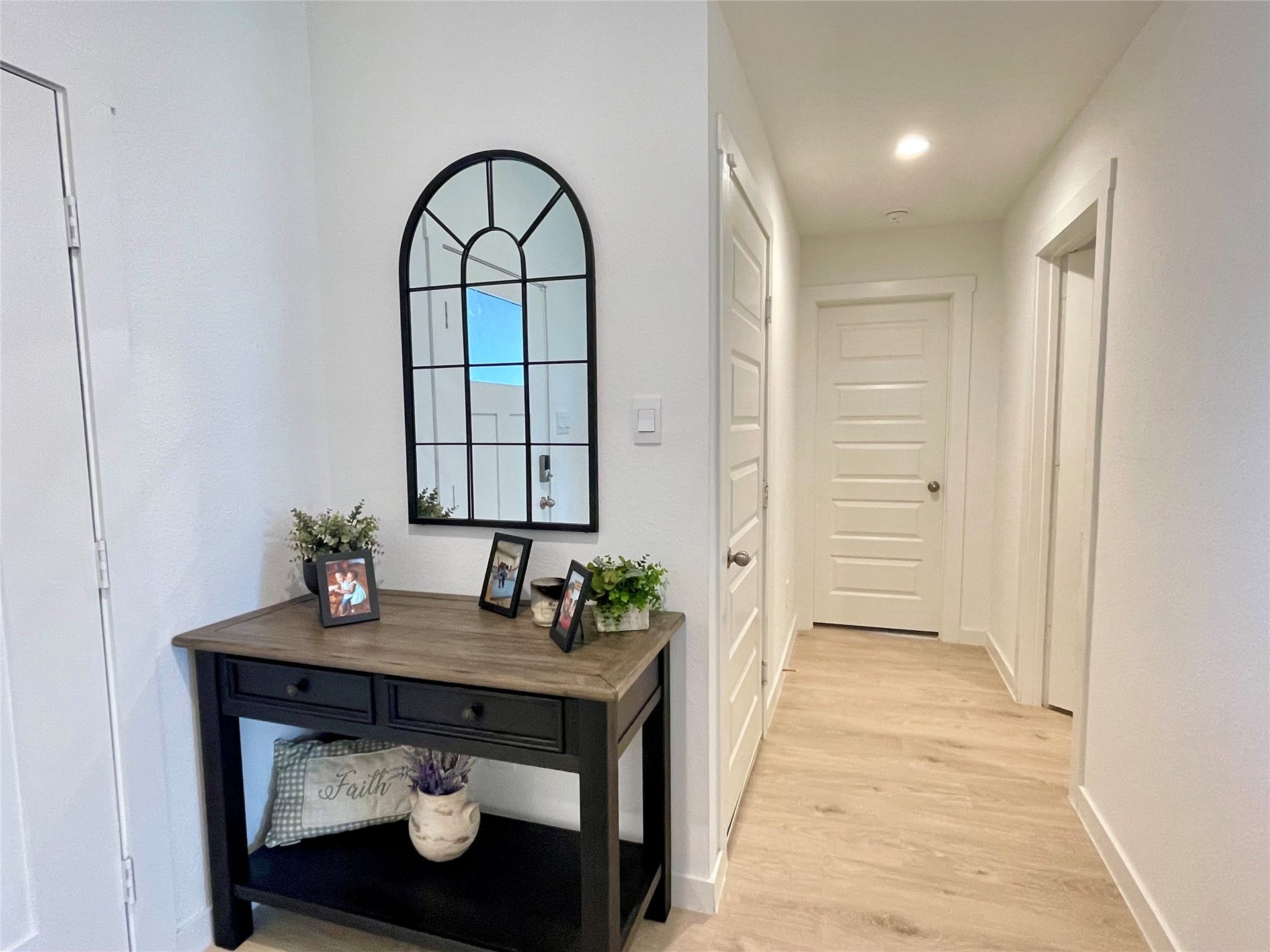 31722 Farlam Farms Trail, Fulshear, TX 77441 Elegant entry hallway featuring stylish accent furniture placement and a seamless transition into the heart of the home.