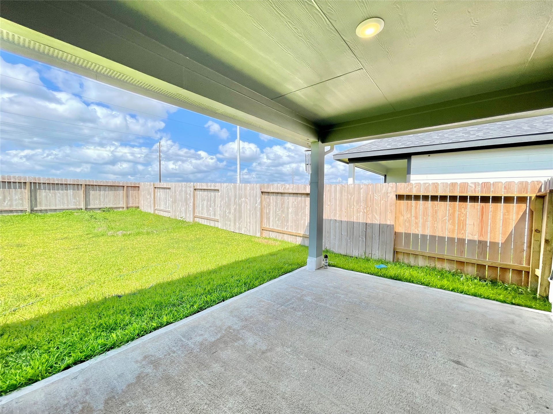 31722 Farlam Farms Trail, Fulshear, TX 77441 The deep, sheltered patio design provides the perfect shade while overlooking the lush, private green yard.