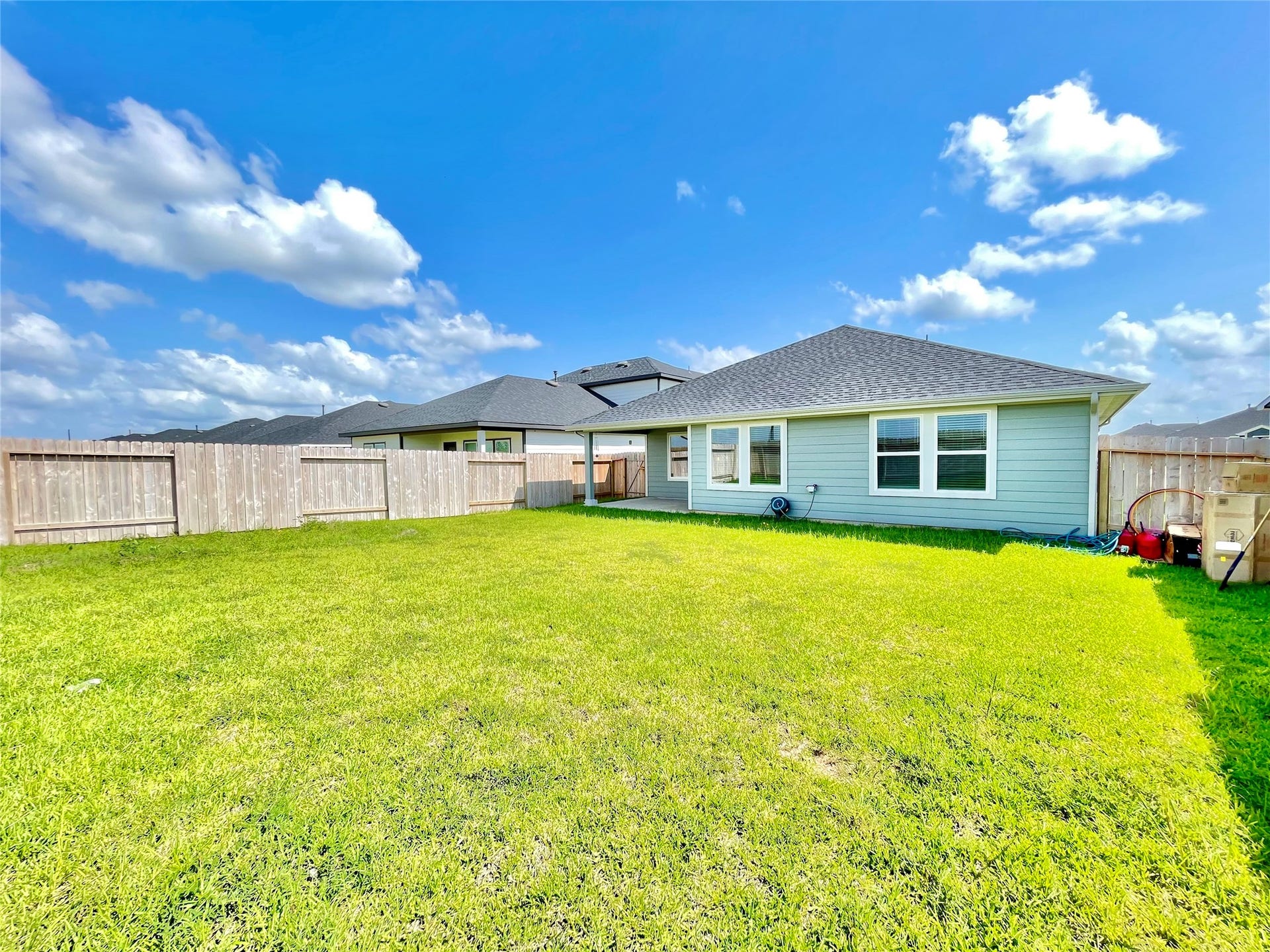 31722 Farlam Farms Trail, Fulshear, TX 77441 Soak in the blue skies! This wide-angle perspective showcases the ultimate privacy and space of your outdoor sanctuary.