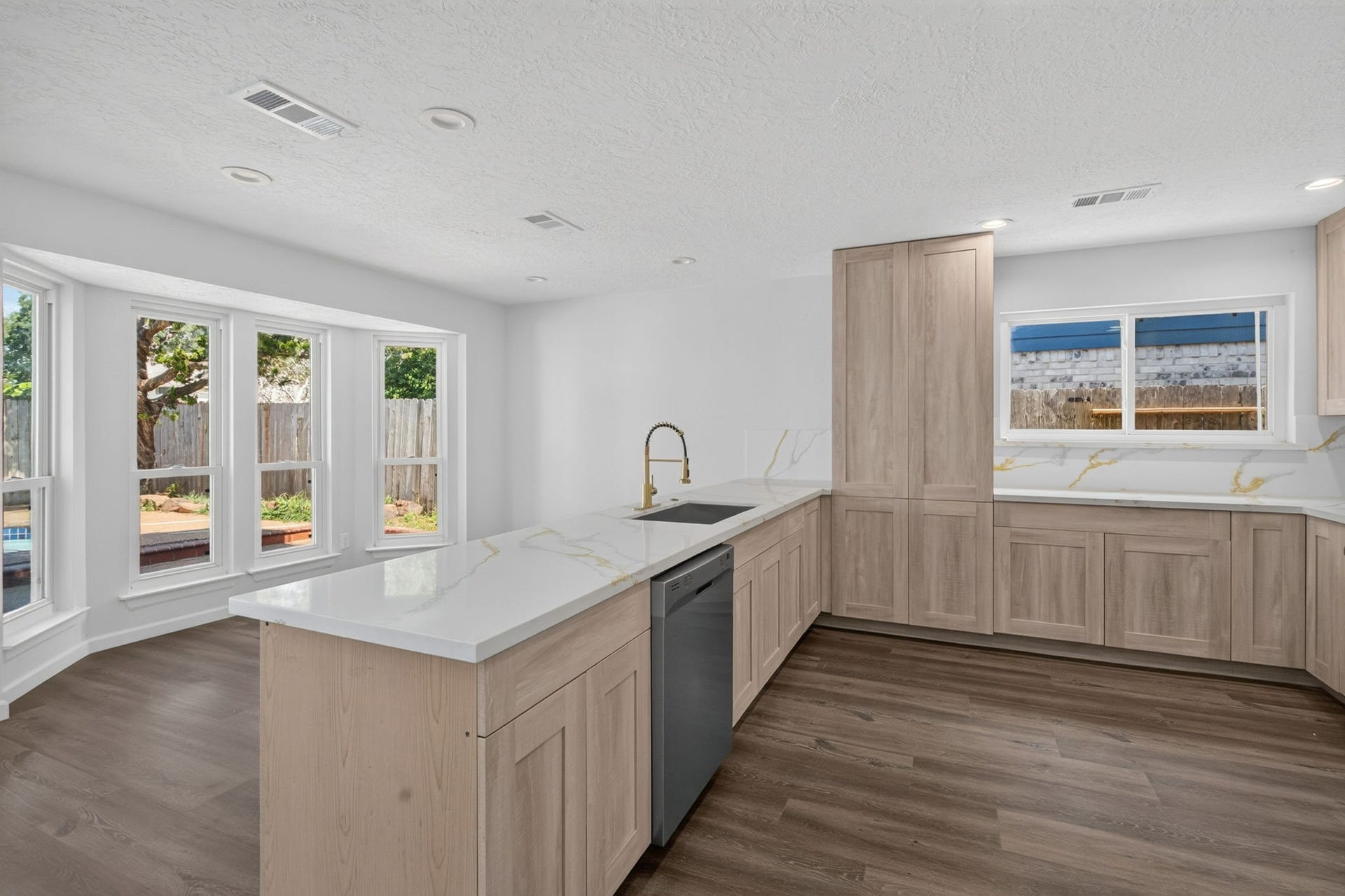 1123 Mayweather Lane, Richmond, TX 77406 A bright, beautifully updated kitchen designed for everyday ease, with generous prep space, abundant cabinetry, and an open connection to the homes living areas.