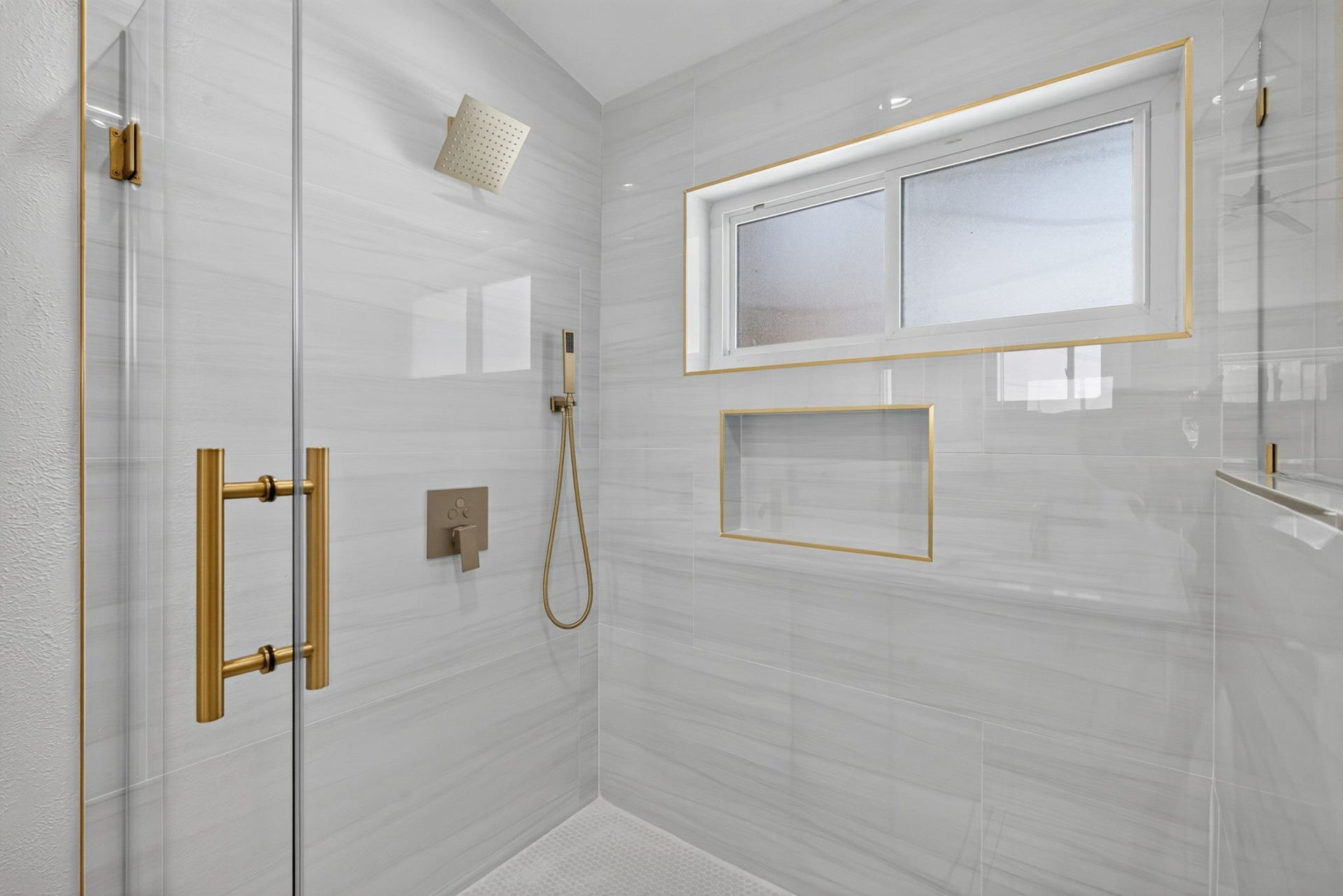 1123 Mayweather Lane, Richmond, TX 77406 A spa-like shower with a rainfall fixture, sleek glass enclosure, and luxe gold detailing turns the daily routine into something special.