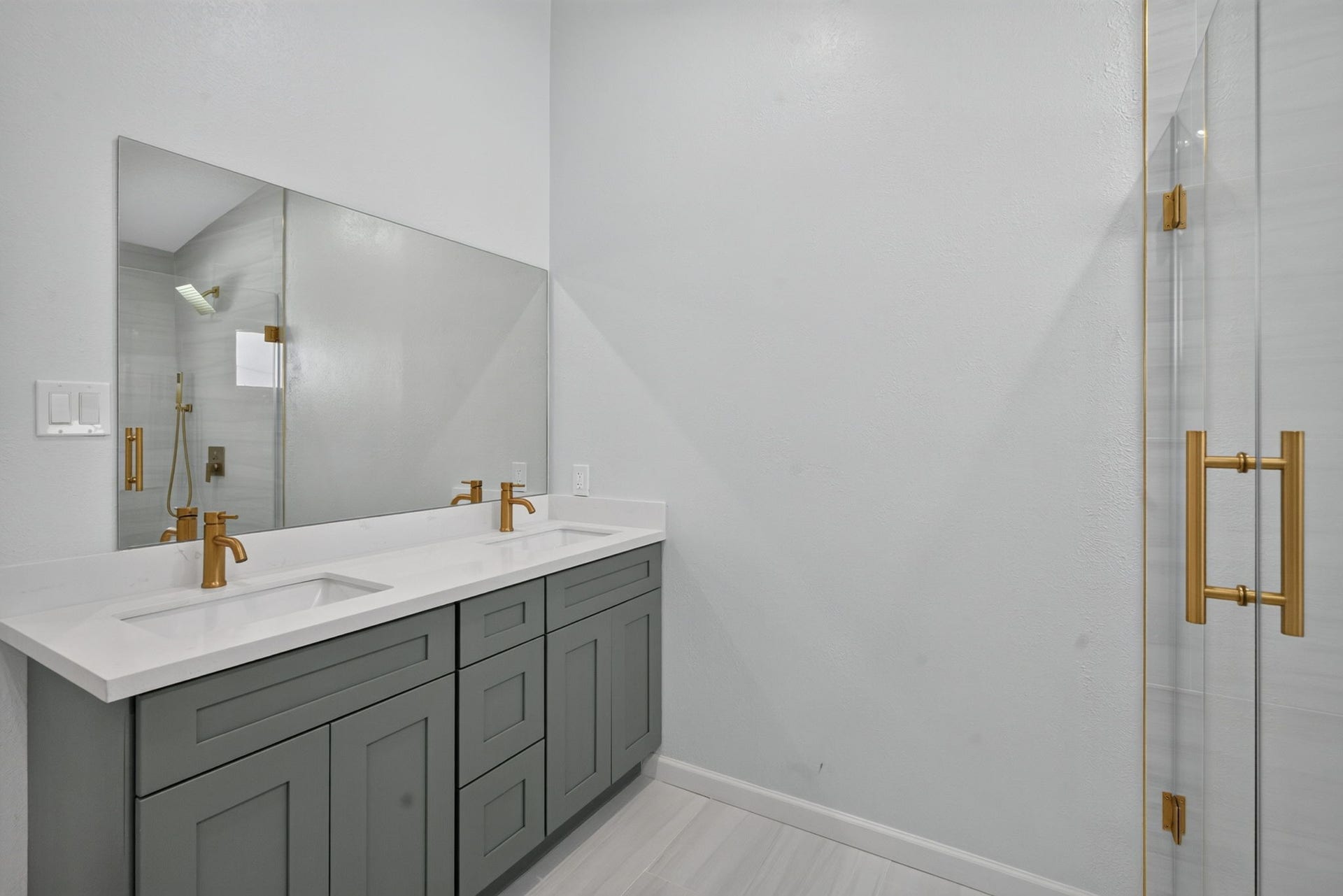 1123 Mayweather Lane, Richmond, TX 77406 Clean contemporary design meets elevated style, with dual sinks and striking gold accents creating a polished retreat for two.