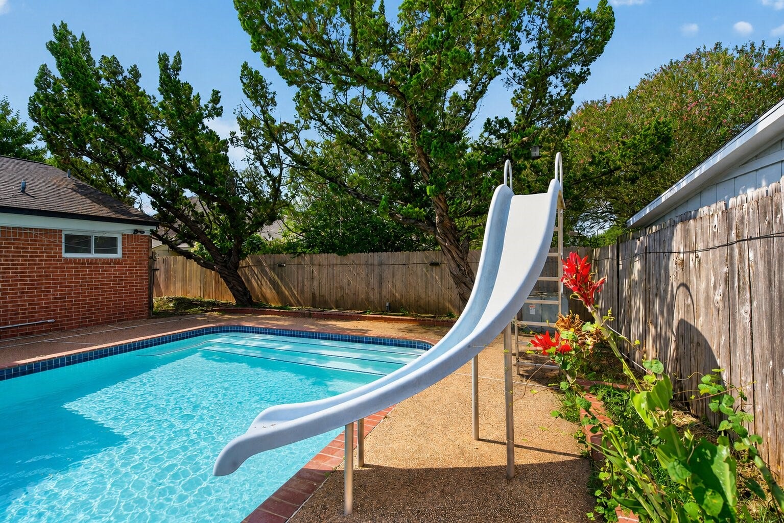 1123 Mayweather Lane, Richmond, TX 77406 Turn everyday afternoons into a getaway with your own private pool and slide, summer fun is already built in.