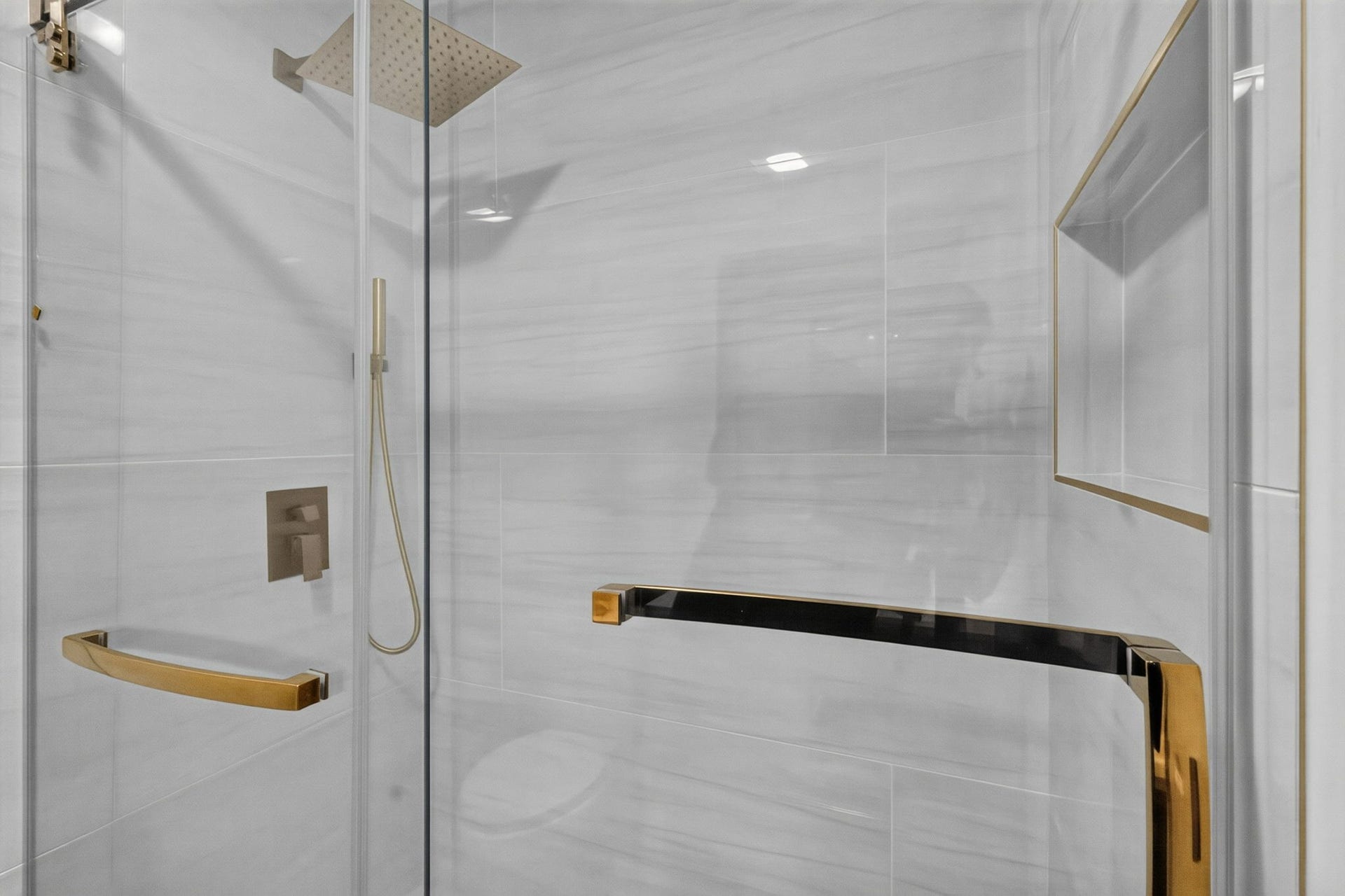 1123 Mayweather Lane, Richmond, TX 77406 A spa-like shower with a rainfall fixture, sleek glass enclosure, and luxe gold detailing turns the daily routine into something special.