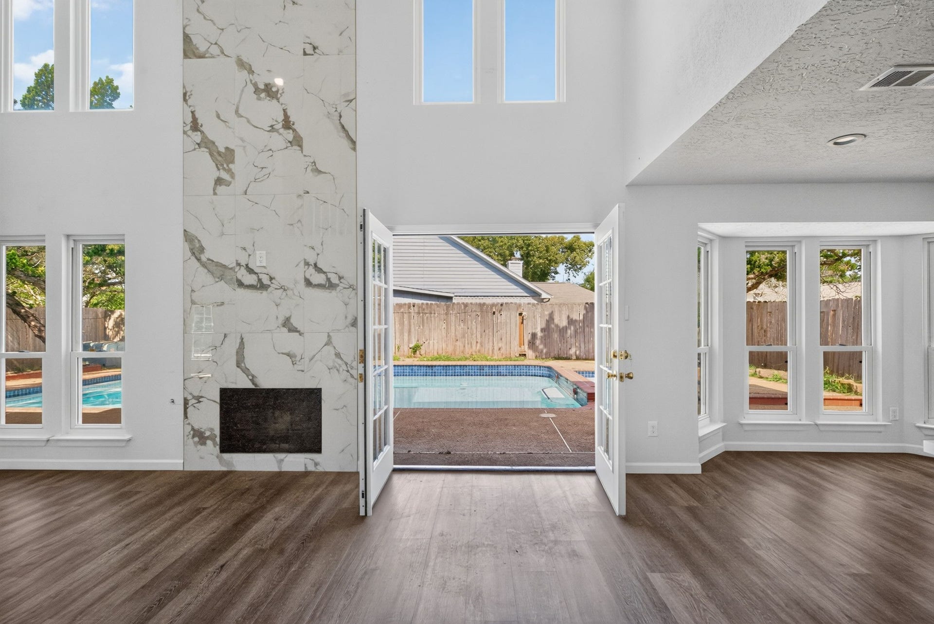 1123 Mayweather Lane, Richmond, TX 77406 A dramatic fireplace and direct pool access create a showstopping living space made for entertaining in every season.