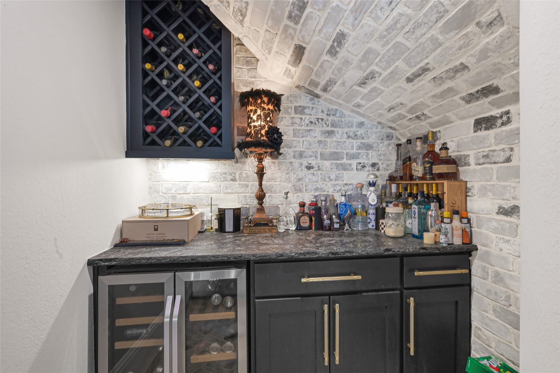 23610 Thortons Park Lane, Spring, TX 77389 Wine grotto featuring a custom brick accent wall and built-in beverage center.