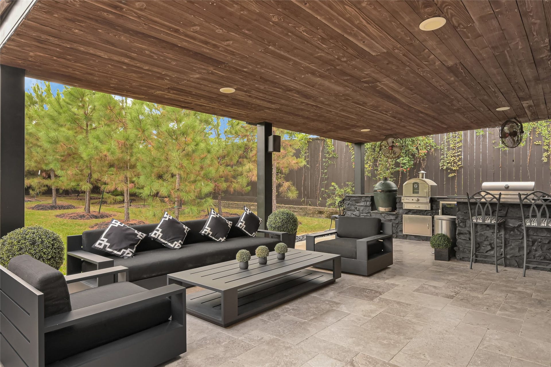 23610 Thortons Park Lane, Spring, TX 77389 Stunning modern outdoor kitchen featuring black Italian granite countertops, a built-in grill, Big Green Egg, and a dedicated beverage refrigerator.
