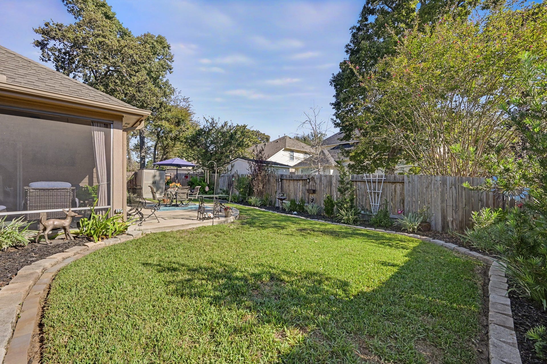 2039 Borthwick Lane, Conroe, TX 77301 This yard offers it all. Screened porch, extended patio & plenty of grassy space for play.