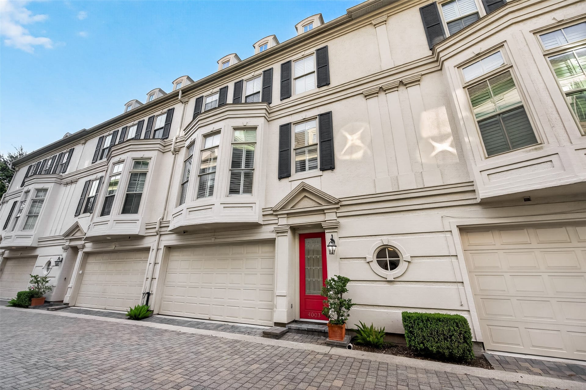 4003 Bellefontaine Street, Houston, TX 77025 Timeless elegance at 4003 Bellefontaine. This distinguished three-story townhome features a classic faade, striking bay windows, black shutters and a welcoming red front door. A two-car garage and brick-paved motor court complete its refined curb appeal.