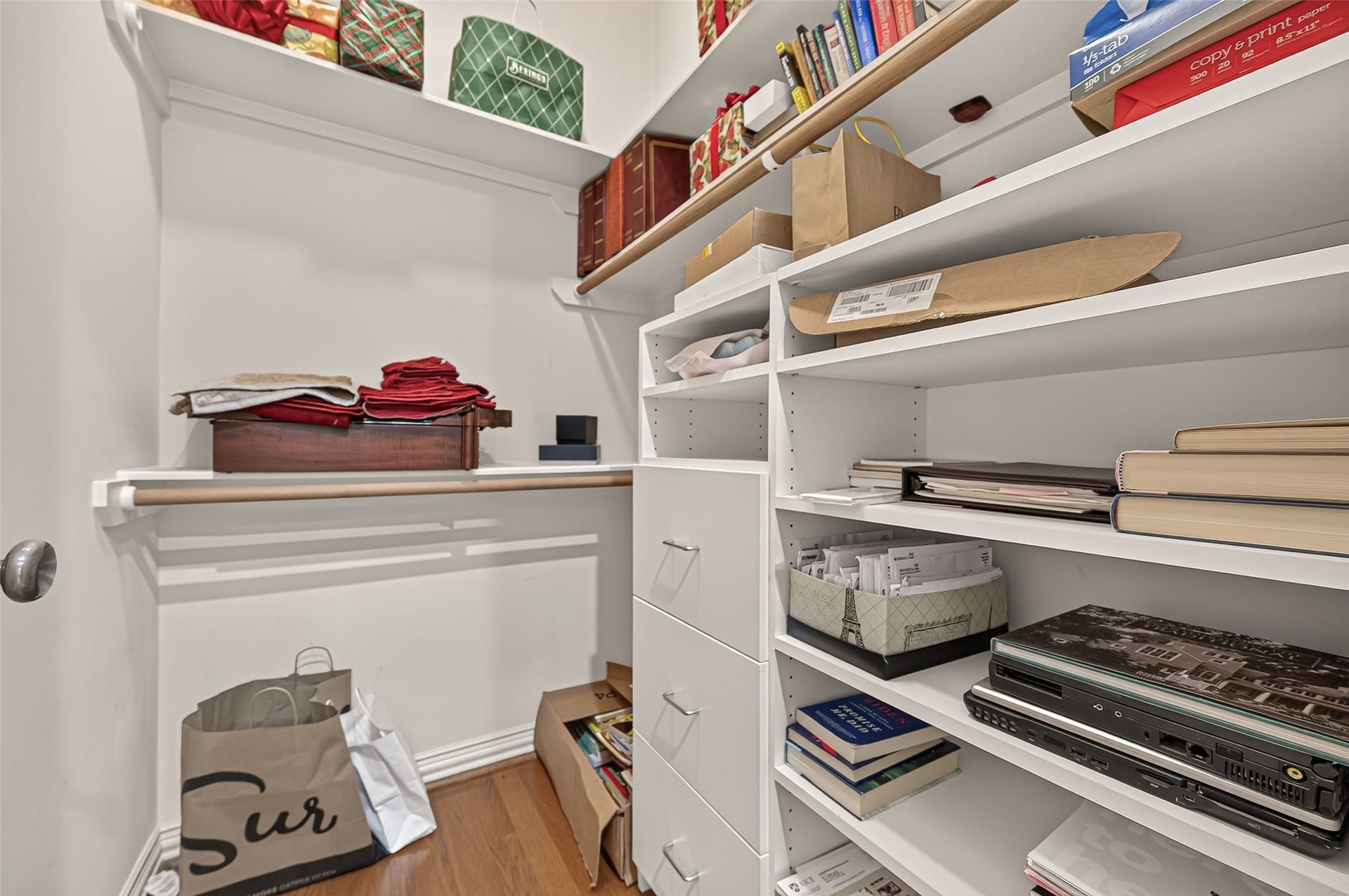 4003 Bellefontaine Street, Houston, TX 77025 The primary suites second walk-in closet offers generous hanging space, overhead shelving, and additional drawer and cubby storage. Hardwood flooring adds a warm finishing touch.