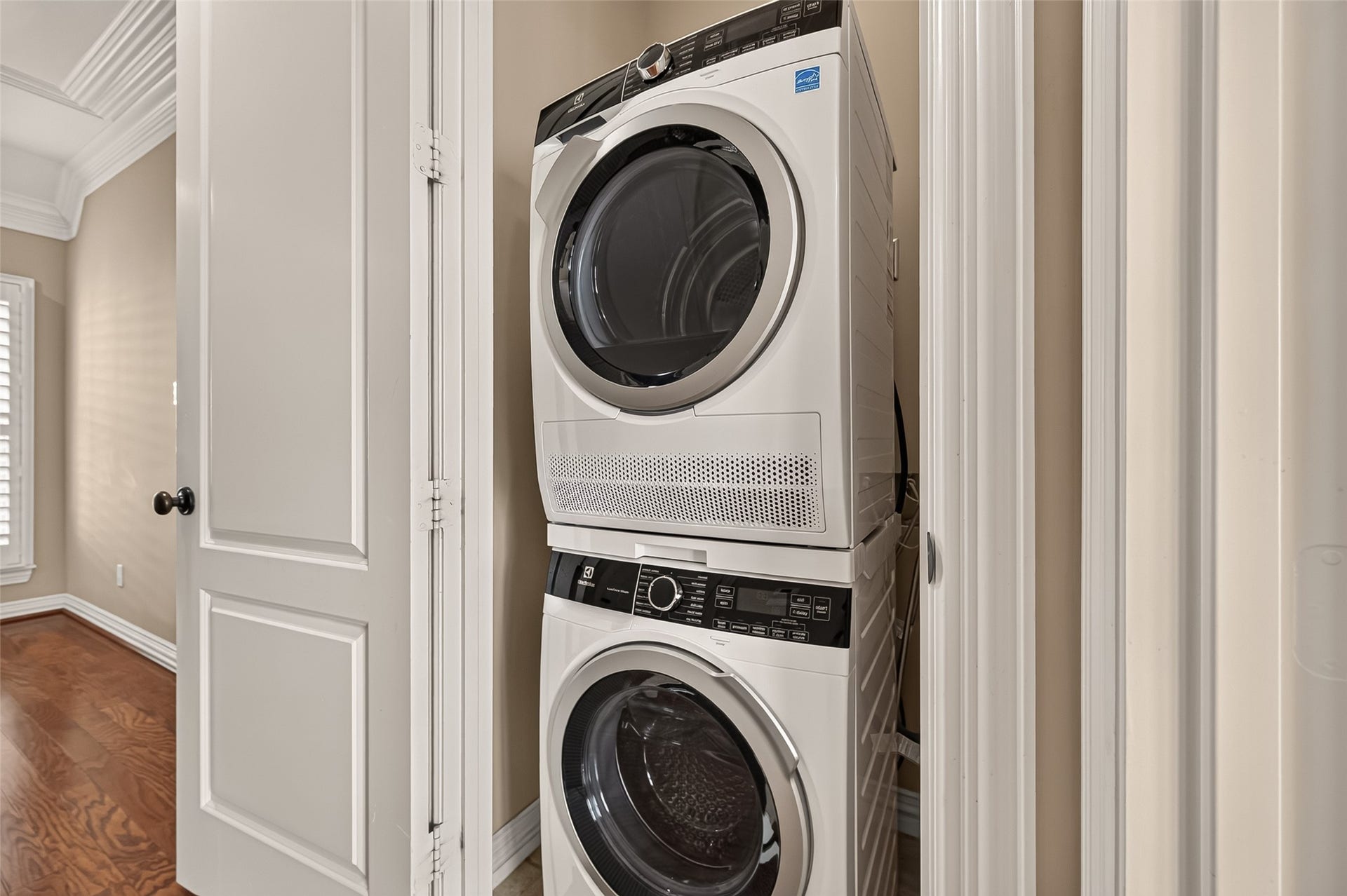 4003 Bellefontaine Street, Houston, TX 77025 Convenient third-floor laundry closet featuring a brand-new Electrolux front-loading washer and dryer in a stacked configuration, ideally located near the bedrooms for everyday ease.