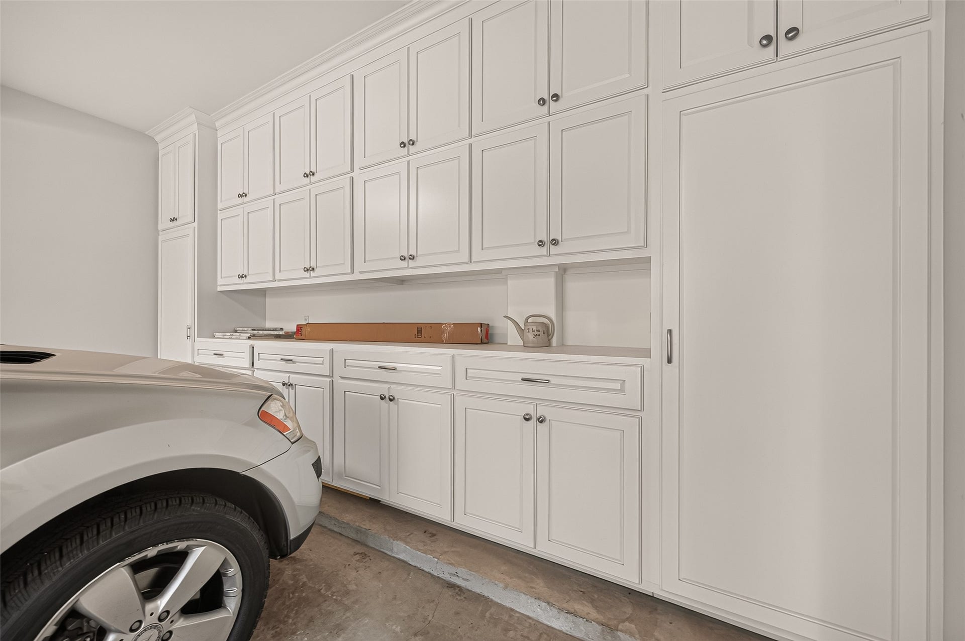 4003 Bellefontaine Street, Houston, TX 77025 Two-car garage featuring extensive built-in cabinetry, drawers, and a convenient work counter. Tall storage cabinets and overhead compartments provide abundant space to keep tools, supplies, and seasonal essentials neatly organized.