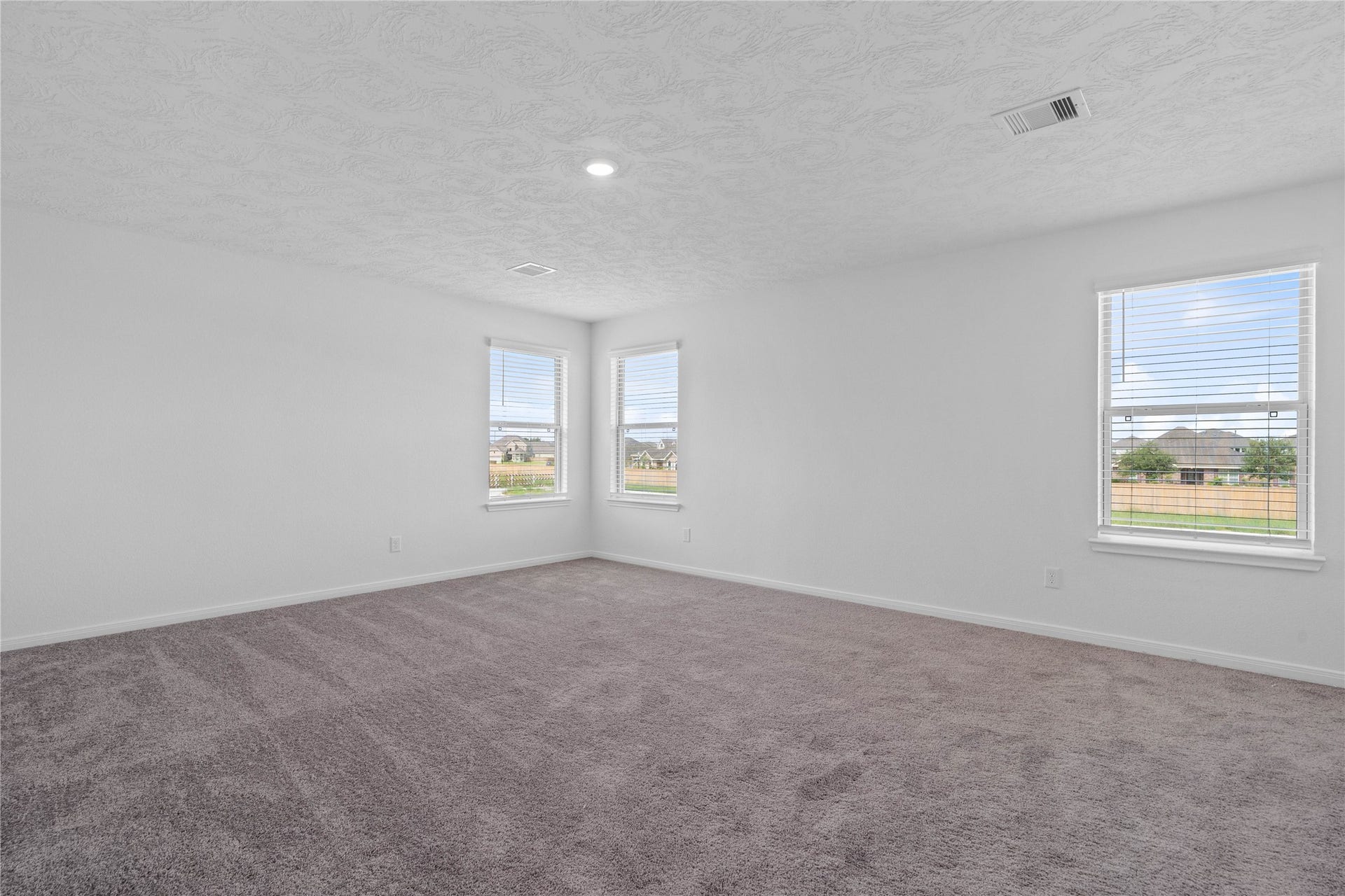 Come upstairs and enjoy a day of leisure in this fabulous and spacious game room! This is the perfect hangout spot or adult game room, this space features plush carpet, high ceiling, recessed lighting, custom paint and plenty of windows that will add natural light!