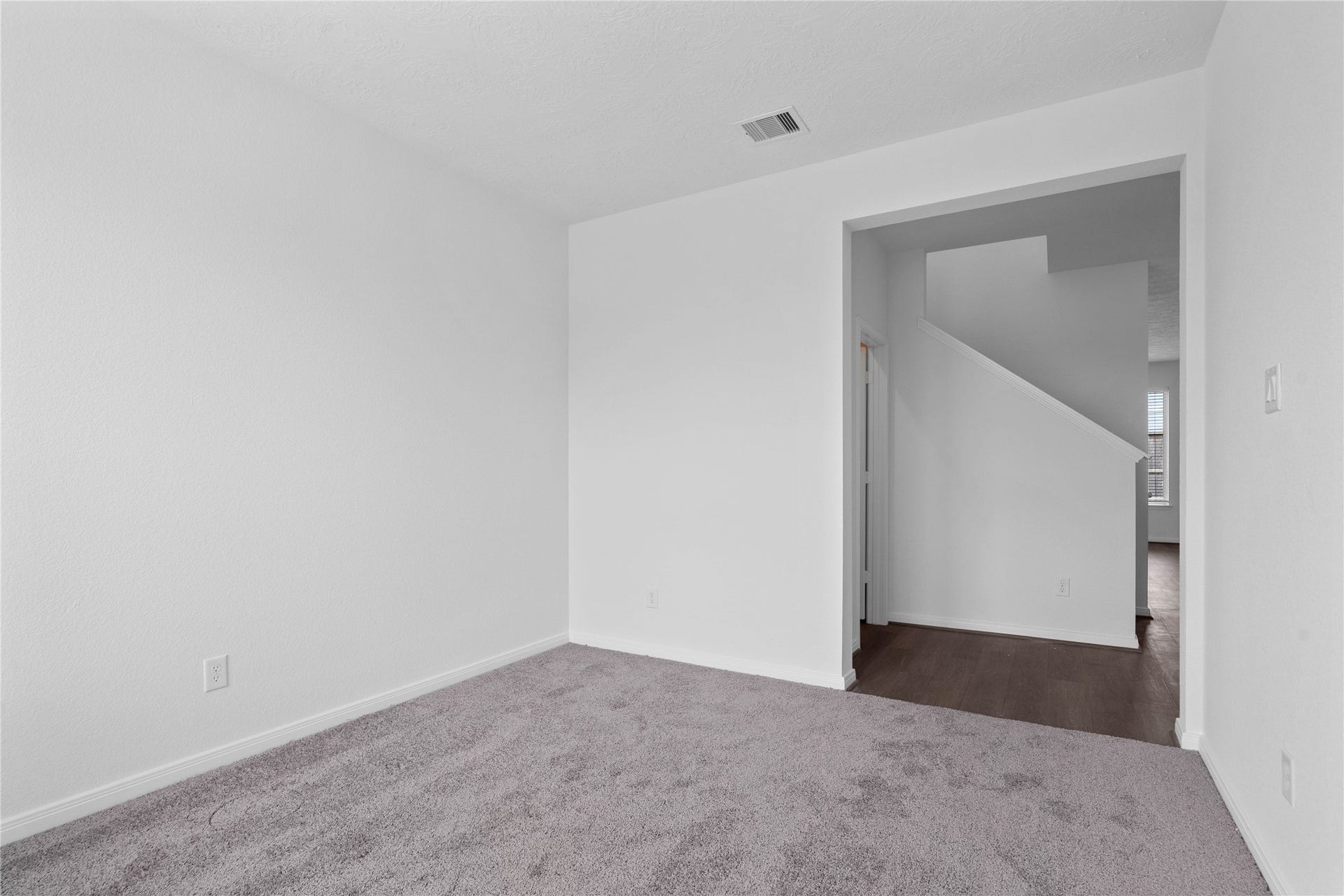 Additional view from Den into hallway. On the left is the powder room and stairs. The Great Room is beyond the staircase.