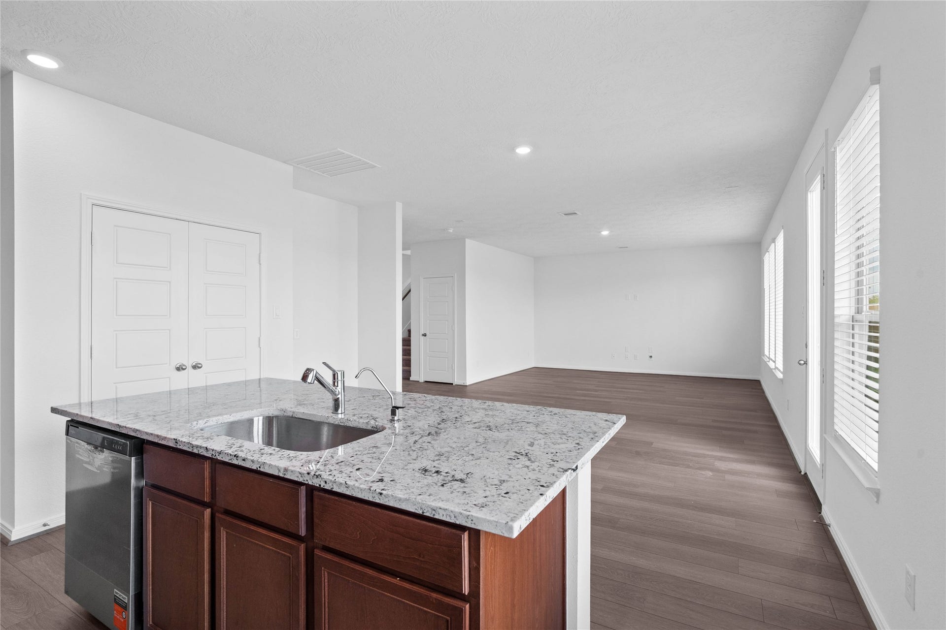 Enjoy a commanding view of the main floor from this perfectly positioned kitchen island, offering the ultimate setup for keeping an eye on the action. The central hub overlooks the expansive layout, making it easy to stay connected to guests or family while preparing meals.