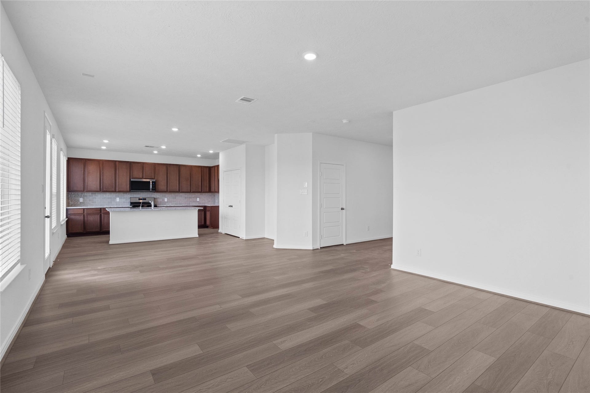 Experience the ultimate in open-concept living with this expansive and sun-drenched main floor layout. The seamlessly connected space provides a versatile footprint, tying the kitchen and living areas together into one cohesive environment.