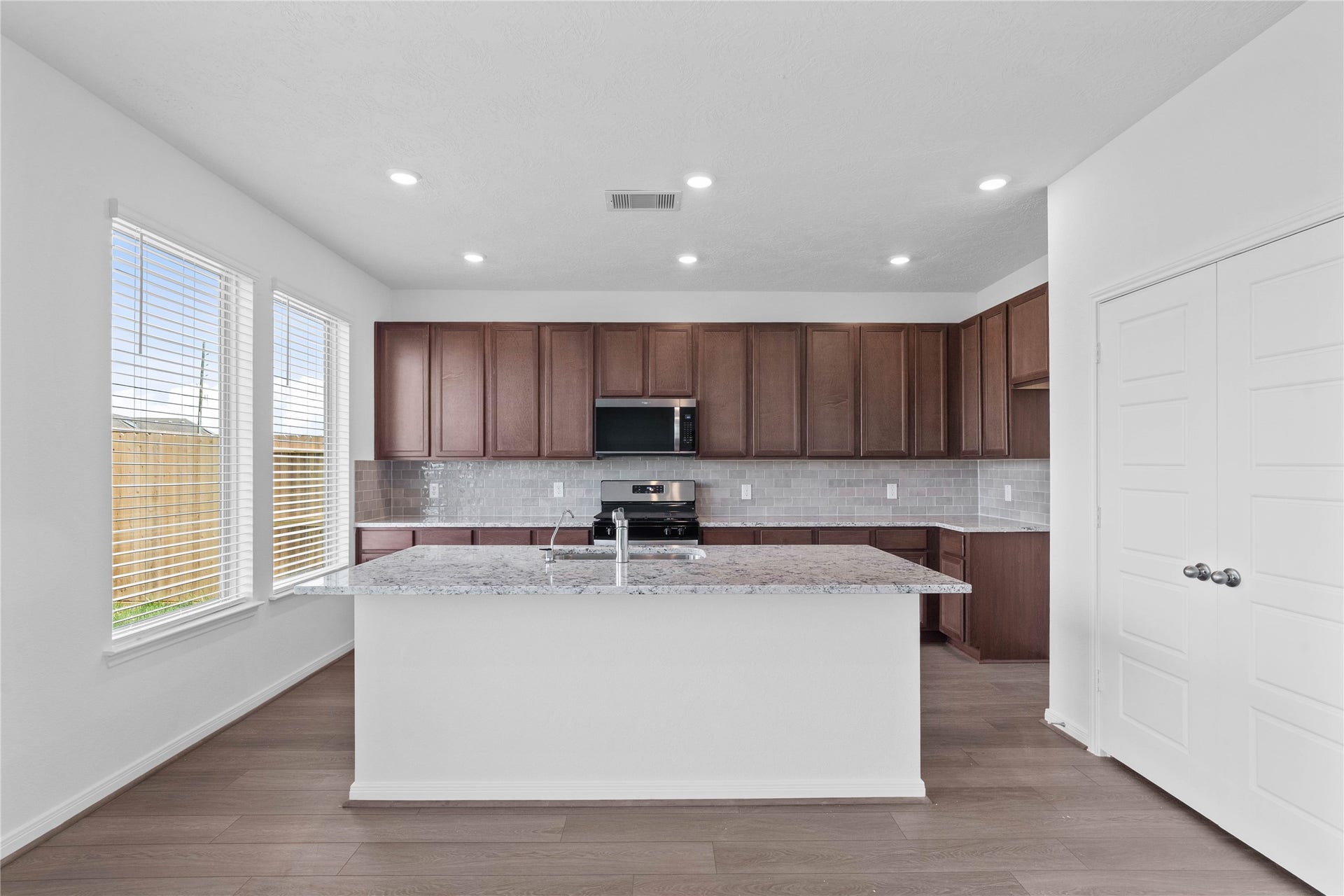This gorgeous kitchen features a large kitchen island and added breakfast bar to kitchen countertop!