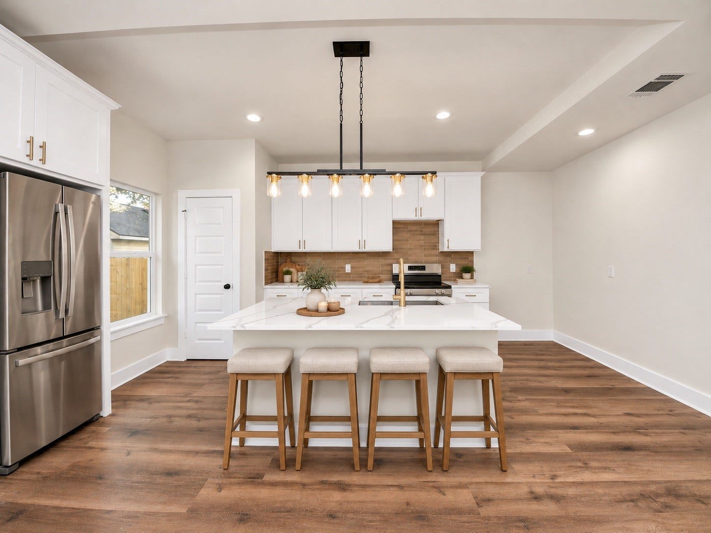 6671 Nielan Street, Houston, TX 77028 Beautifully appointed kitchen featuring quartz countertops, white soft-close cabinetry, stainless steel appliances, stylish pendant lighting & a generously sized center island with bar seating.