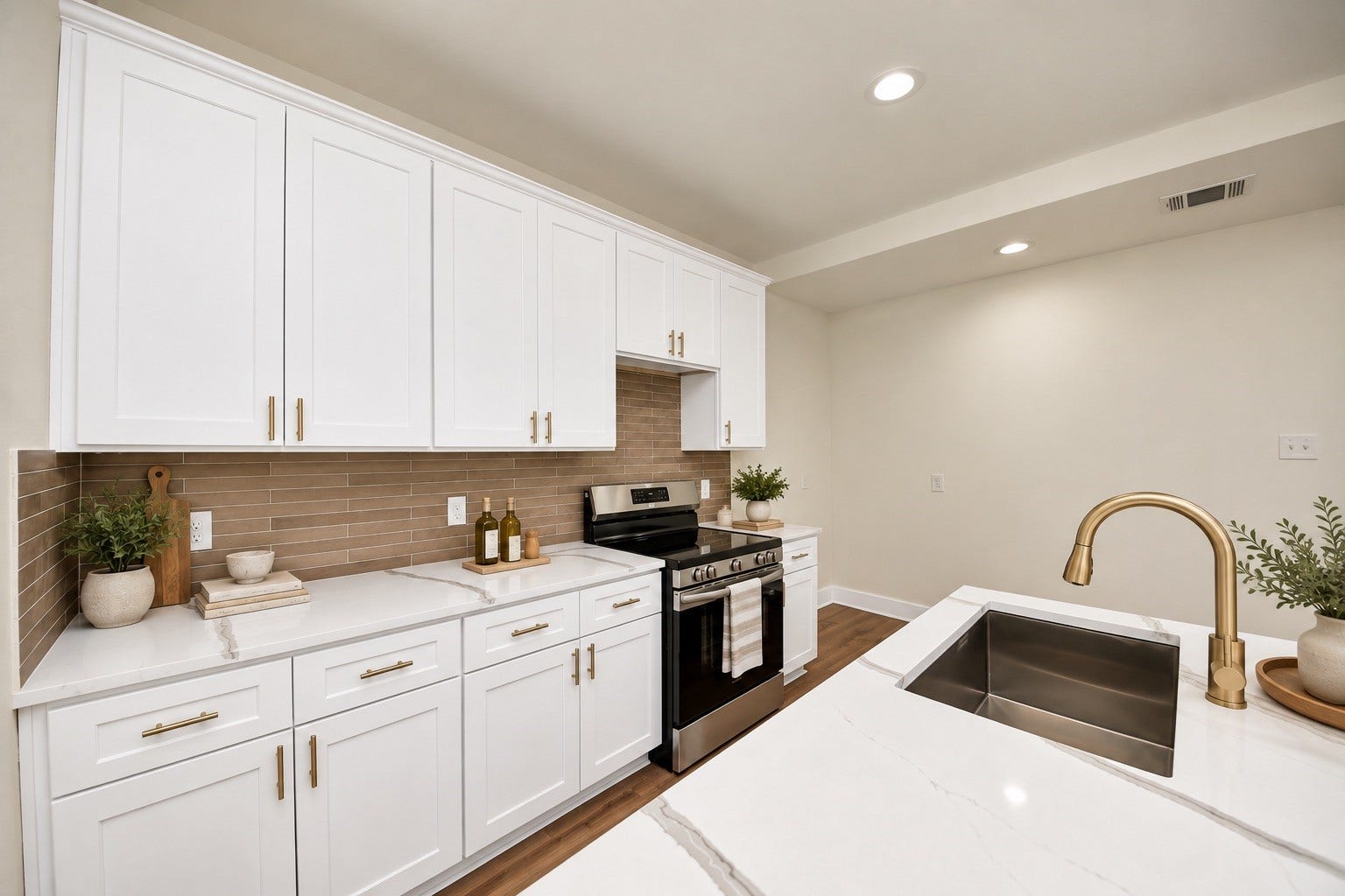 6671 Nielan Street, Houston, TX 77028 Detailed view showcasing white cabinetry with sleek modern hardware pulls, decorative tile backsplash, quartz countertops, stainless steel appliances & ample cabinet storage.