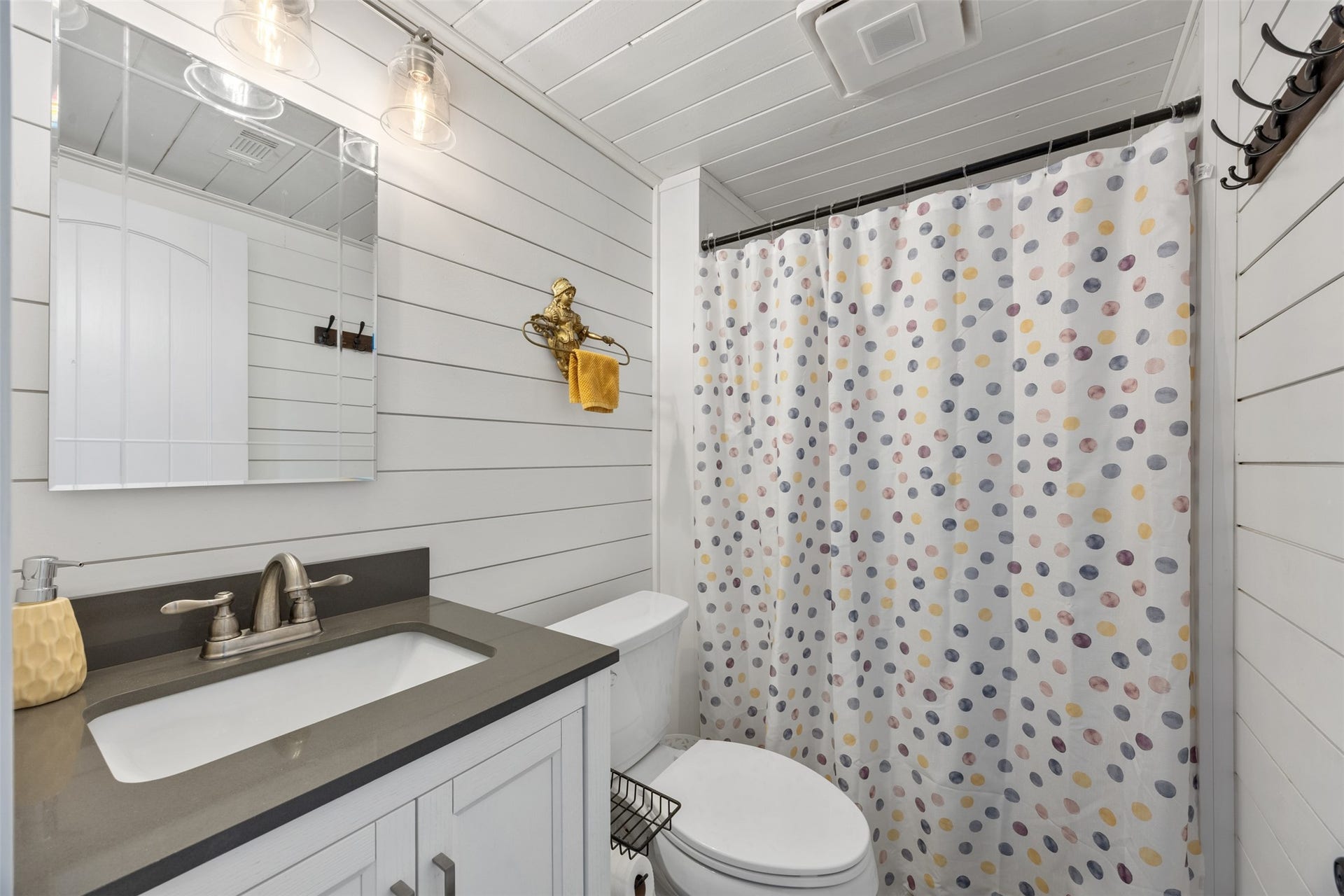 30902 Kate Drive, Magnolia, TX 77355 Guest bathroom shines with new lighting, shiplap walls. Beautiful country feeling
