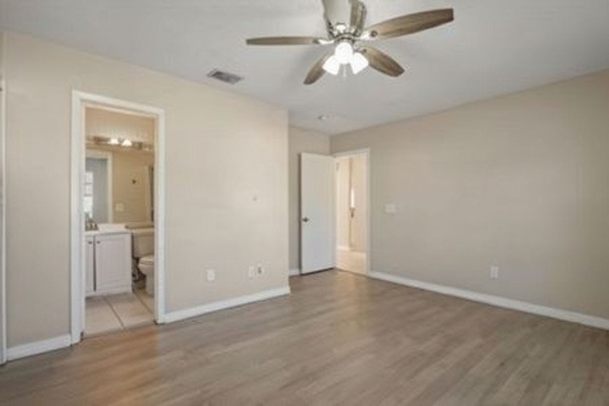 4522 Alamo Avenue, Sugar Land, TX 77479 Primary bedroom with ceiling fan and private bathroom access.