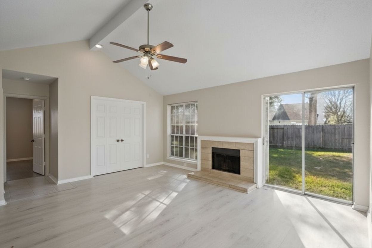 4522 Alamo Avenue, Sugar Land, TX 77479 Alternate view of the living area featuring a vaulted ceiling, fireplace, and backyard access.