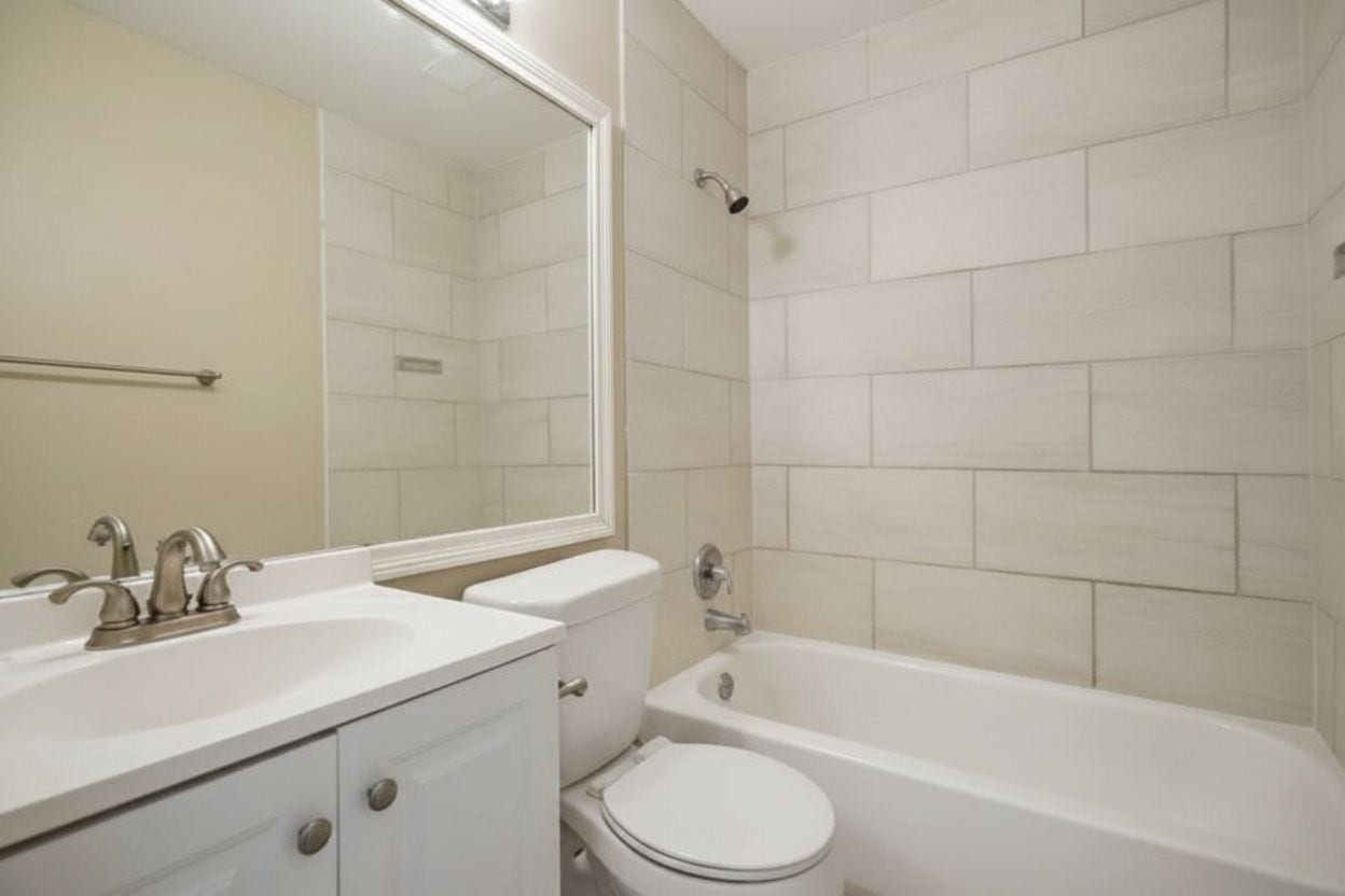 4522 Alamo Avenue, Sugar Land, TX 77479 Full bathroom featuring a vanity and tub/shower combination with tile surround.